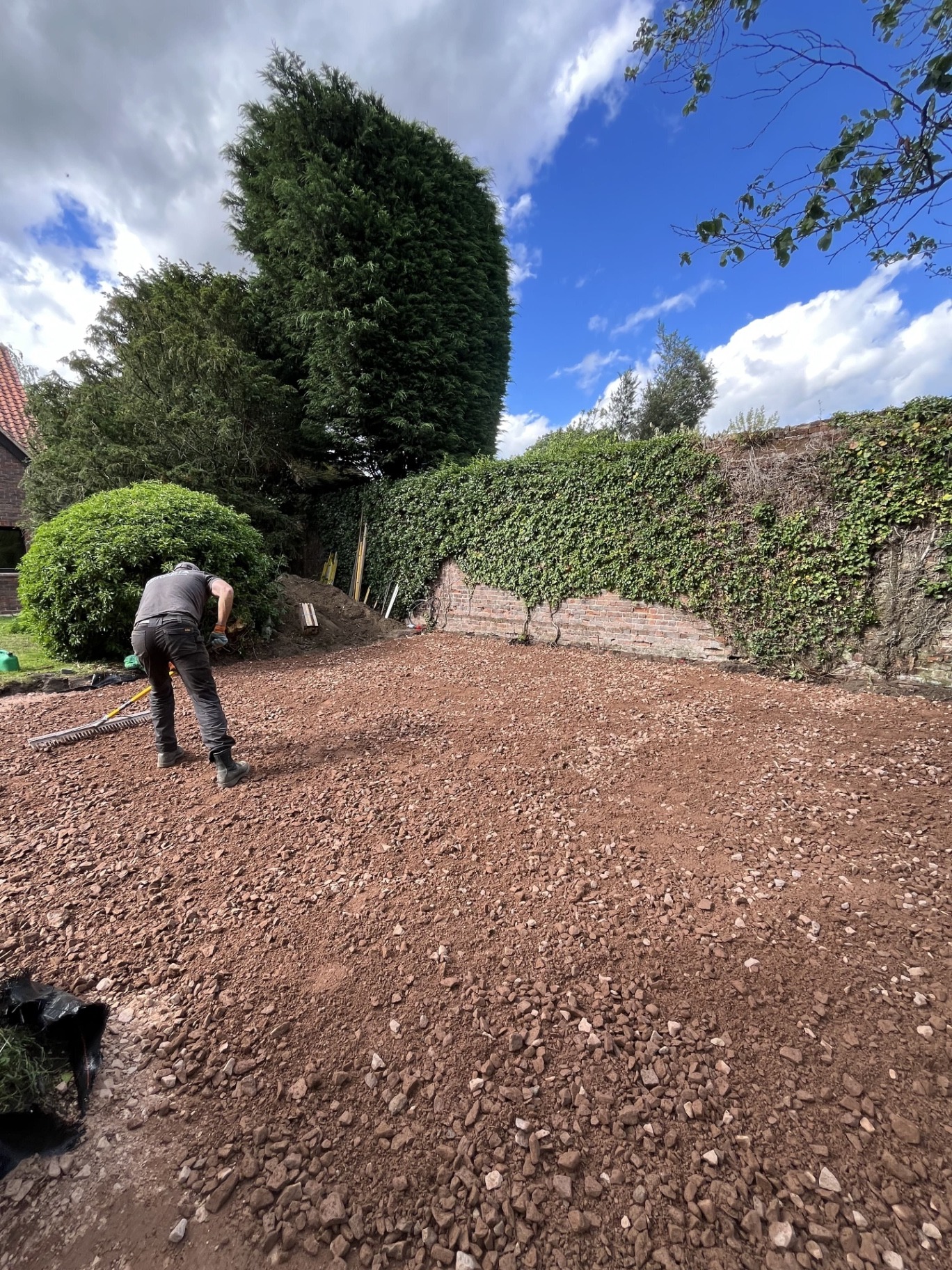 Deep compacted sub-base installed across the Godmanchester garden after soft ground conditions forced the patio build-up to be increased