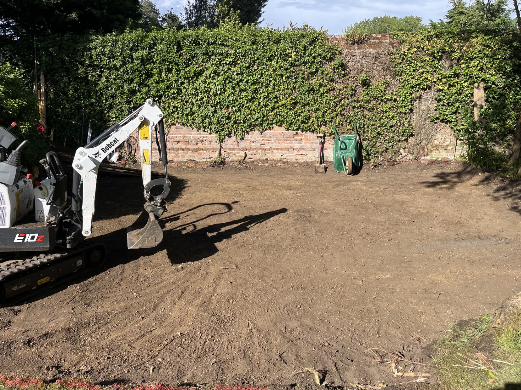 Cleared and excavated patio footprint in Godmanchester after the initial dig-out, exposing the area that would need a deeper sub-base
