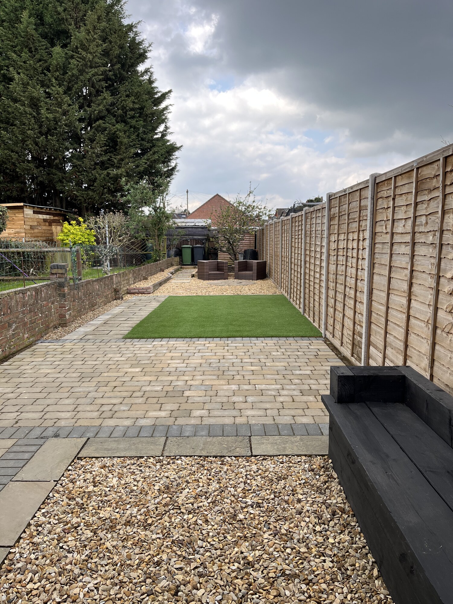 Block paving garden with charcoal borders, artificial grass and new fencing in Fletton, Peterborough