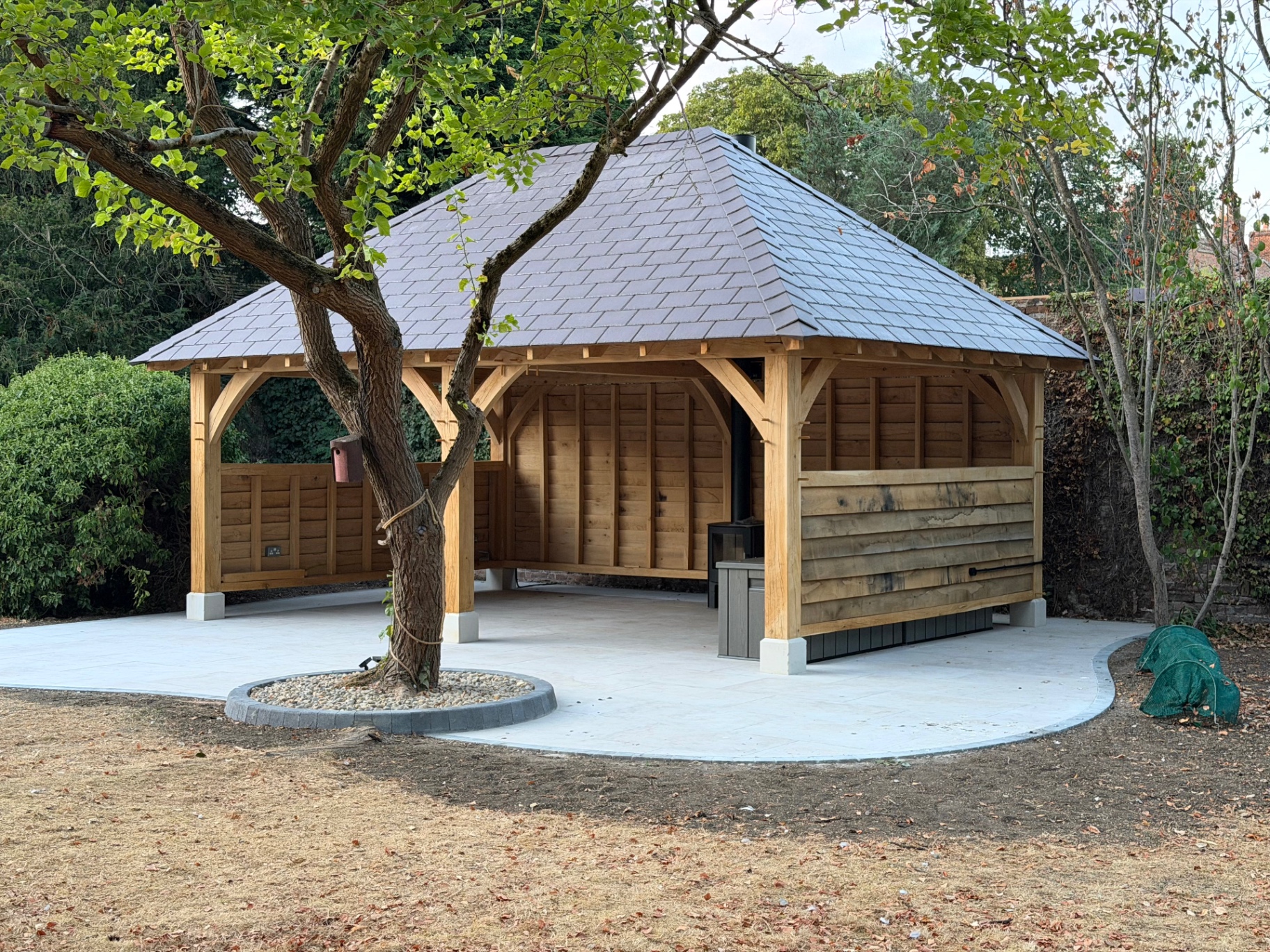 Completed oak gazebo with slate roof and porcelain patio in Godmanchester, Cambridgeshire