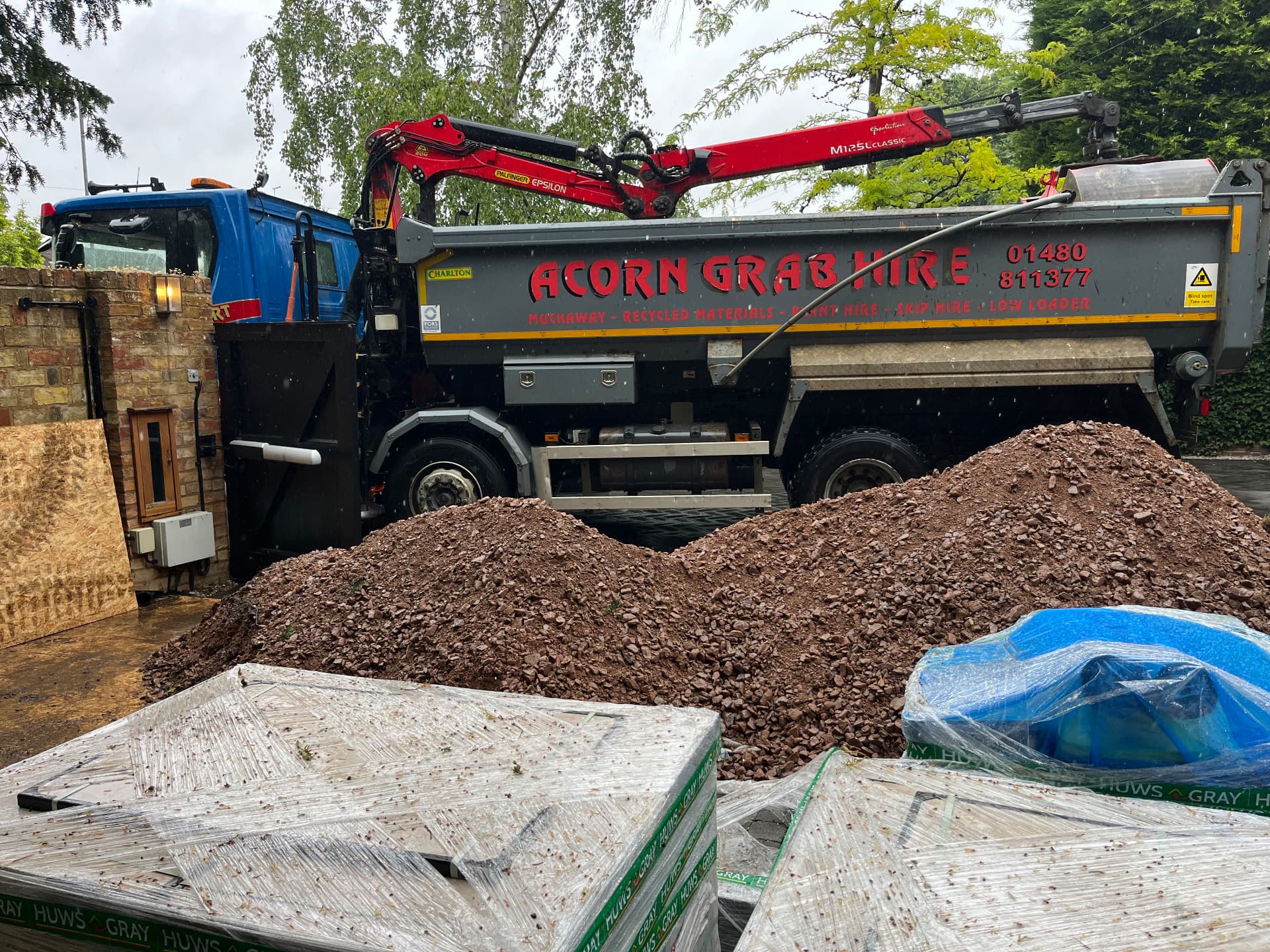 Grab lorry delivering MOT type 1 sub base aggregate in Godmanchester