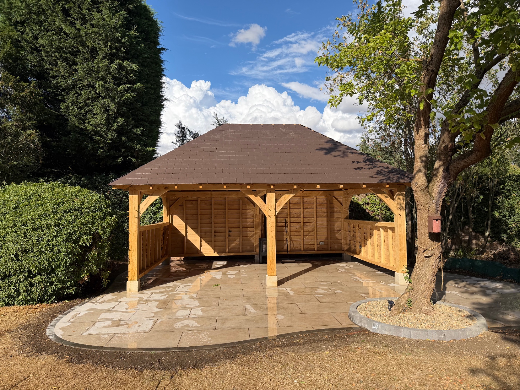 Finished oak gazebo and porcelain patio with tree circle in Godmanchester, Cambridgeshire