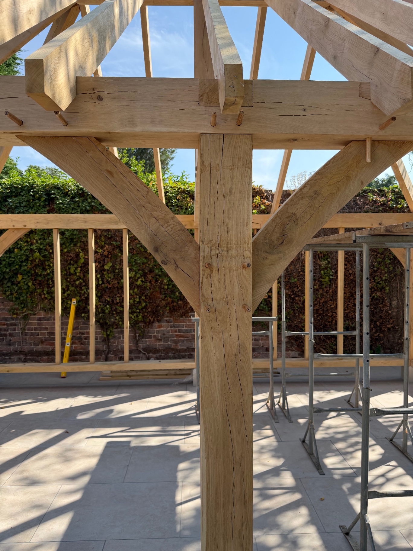 Close up of jointed oak post, beam and curved braces in the gazebo frame in Godmanchester