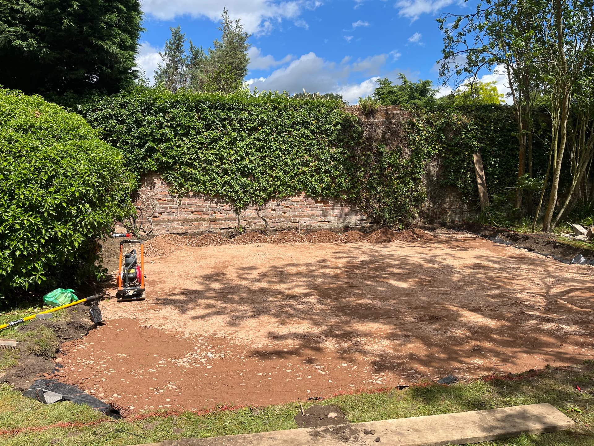 Plate compactor consolidating the sub base in Godmanchester, Cambridgeshire