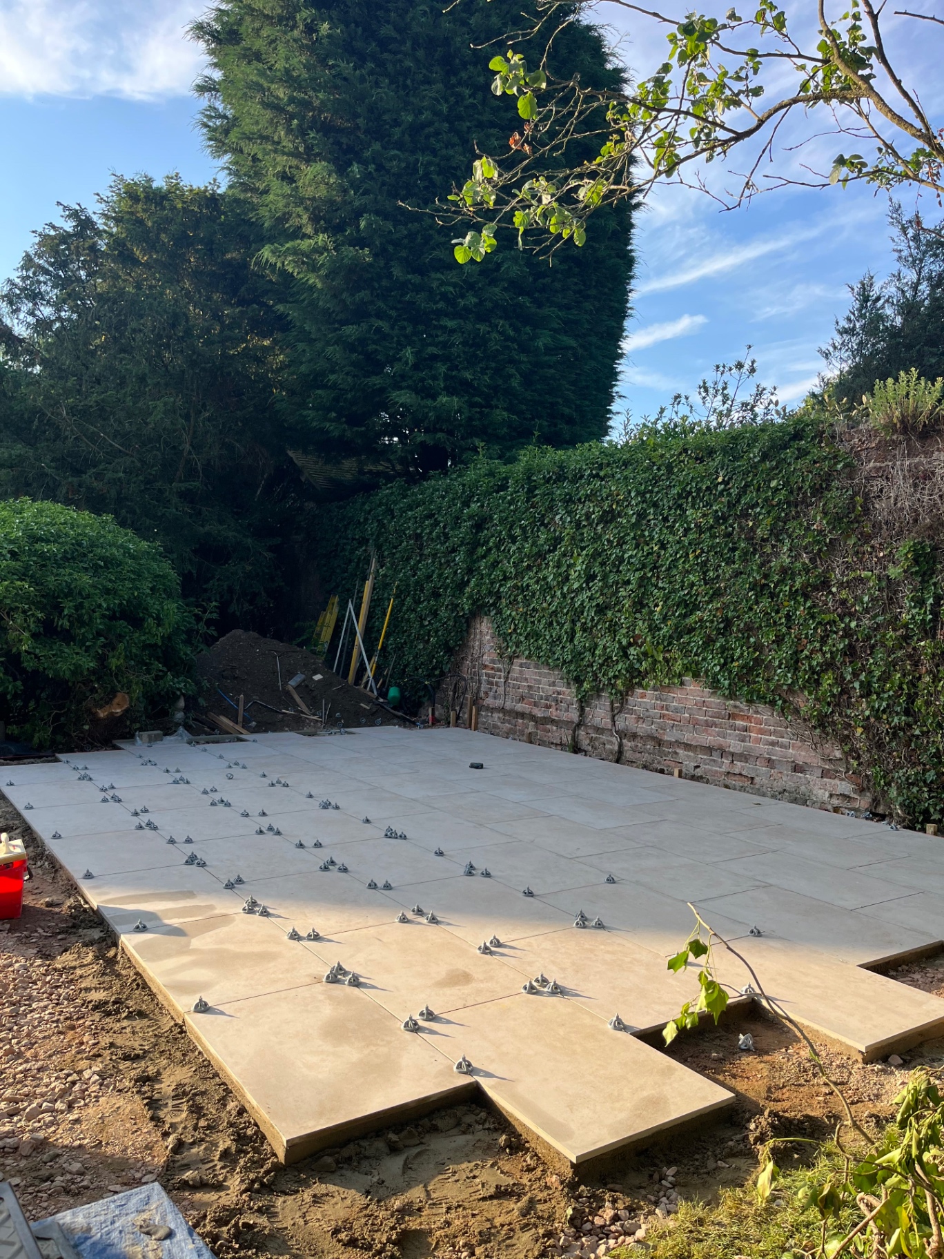 Large porcelain patio laid with levelling clips still in place in Godmanchester