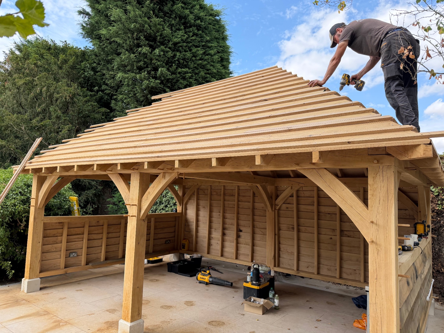 Carpenter fixing roof battens to the oak gazebo in Godmanchester, Cambridgeshire