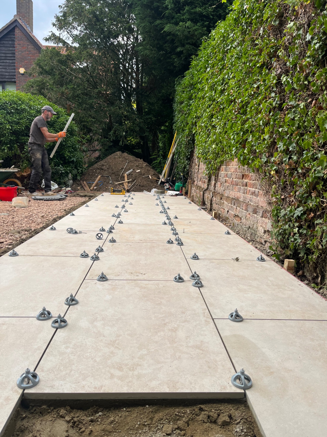Rows of porcelain paving laid with levelling clips in place in Godmanchester