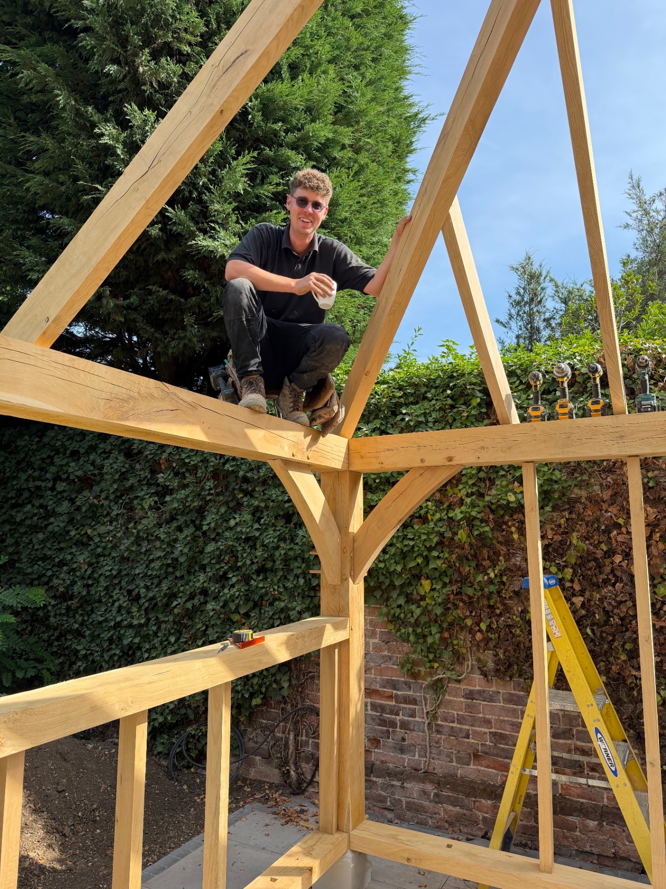 Arcadia Build and Landscape carpenter working on the oak gazebo roof frame in Godmanchester