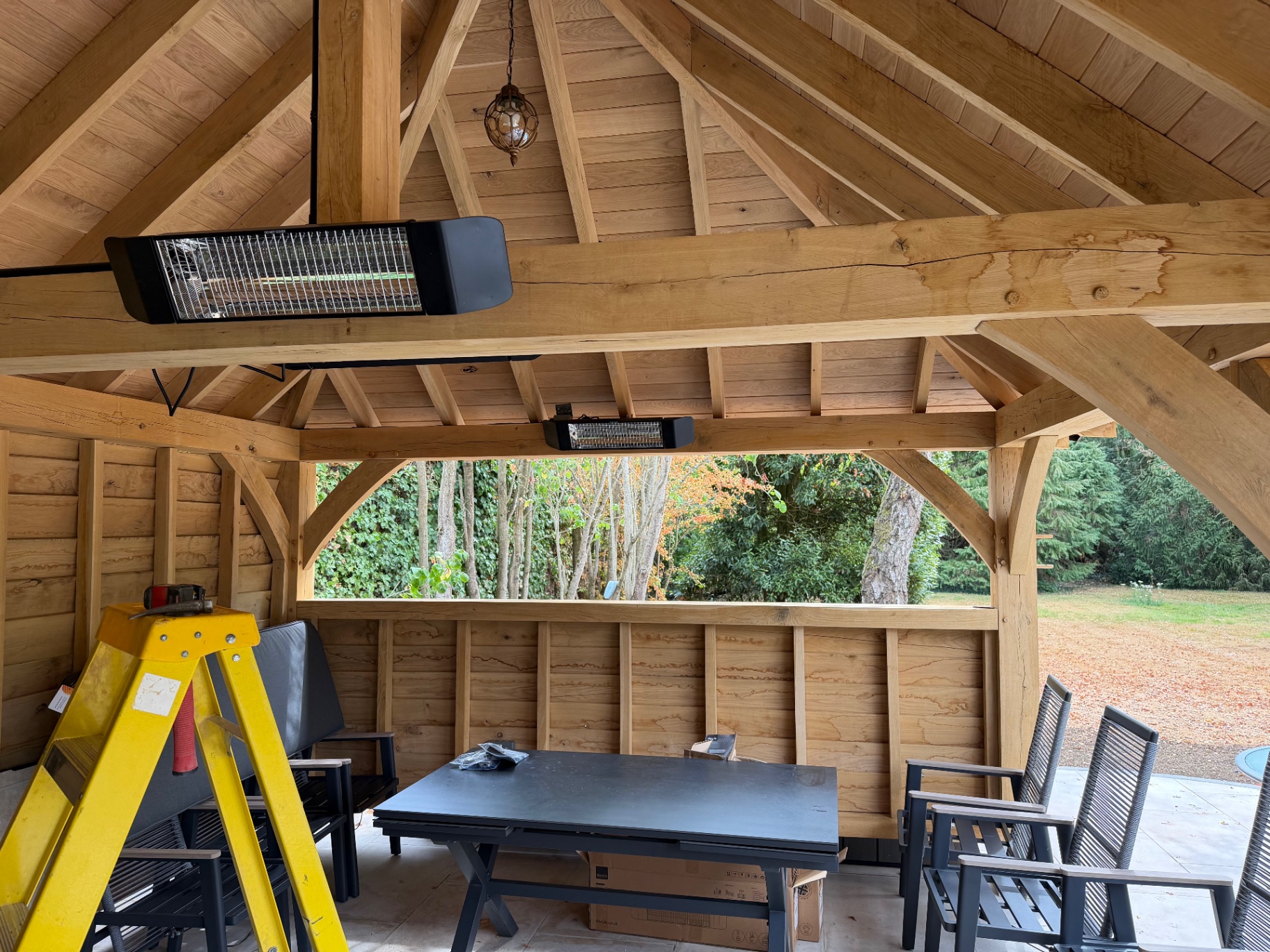 Inside the oak gazebo showing the boarded oak ceiling and overhead heaters in Godmanchester, Cambridgeshire