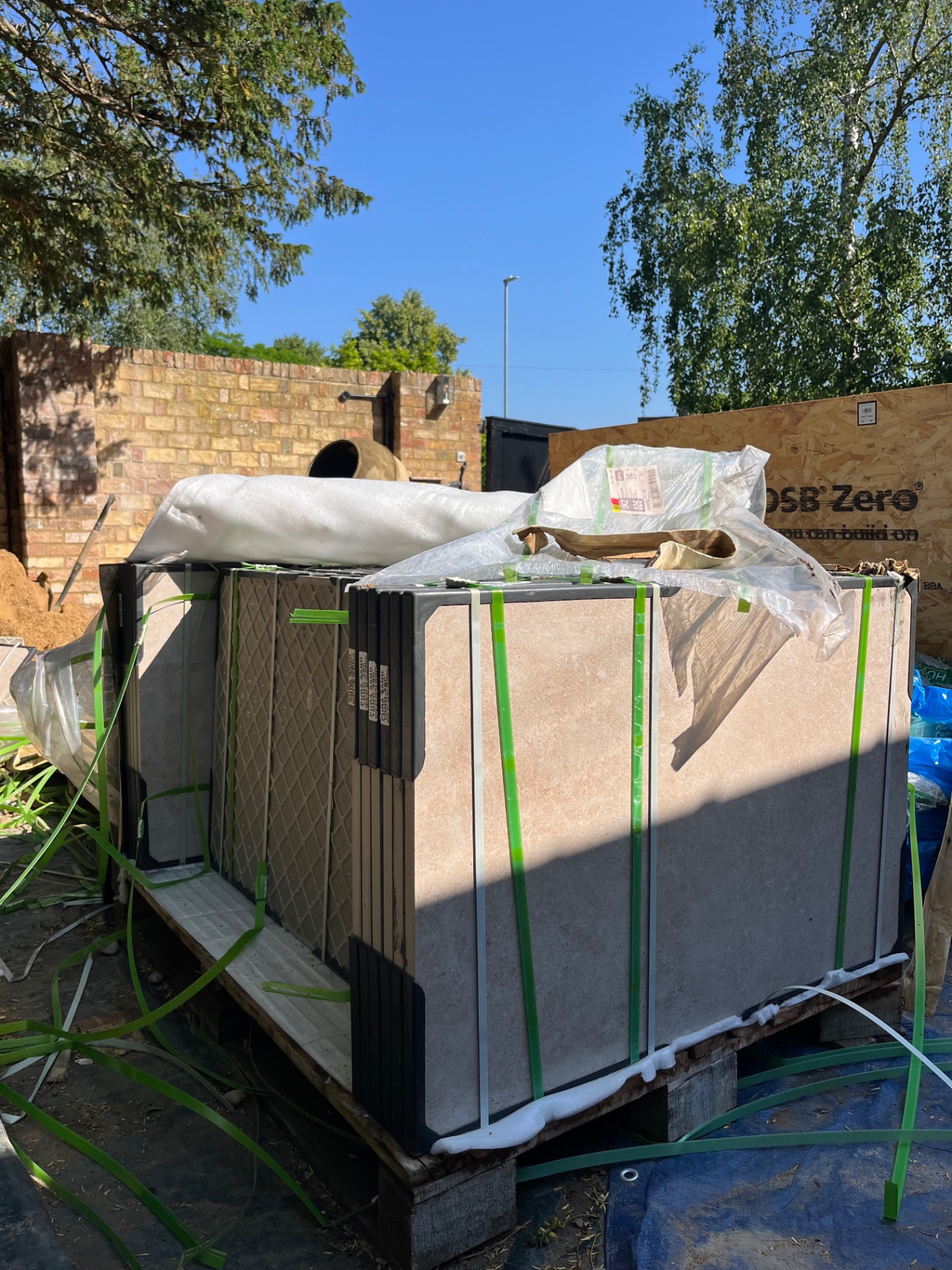 Pallet of large format porcelain paving slabs delivered on site in Godmanchester, Cambridgeshire