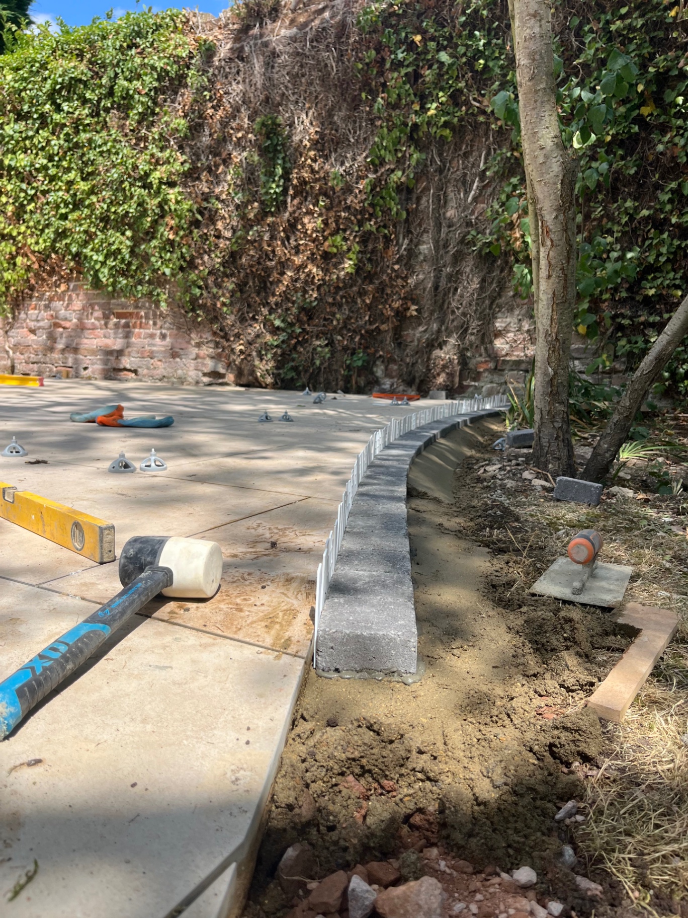 Charcoal sett edging bedded along the curved patio edge in Godmanchester