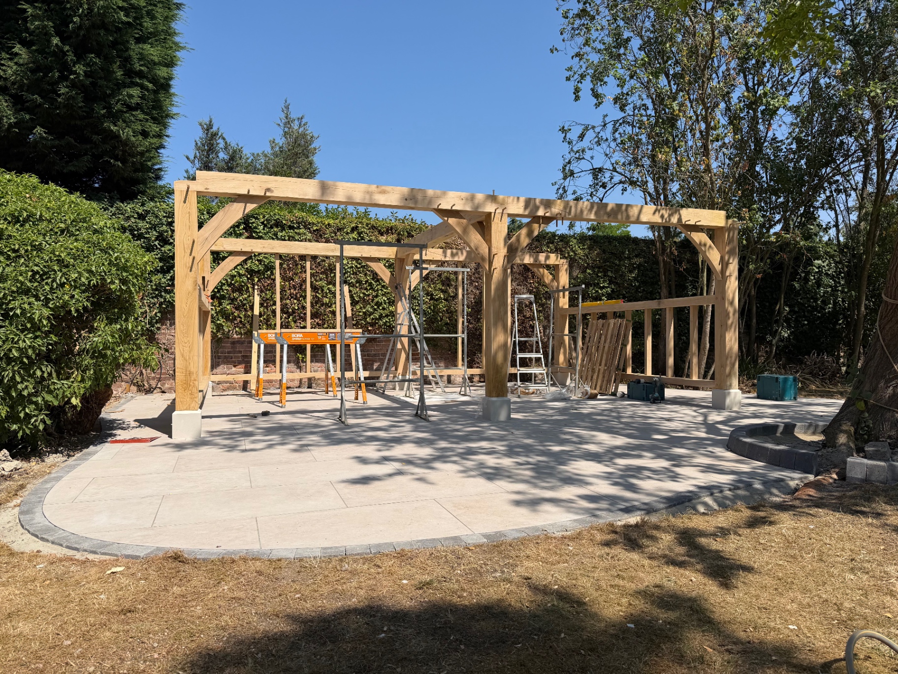 Completed oak gazebo frame standing over the finished porcelain patio in Godmanchester, Cambridgeshire