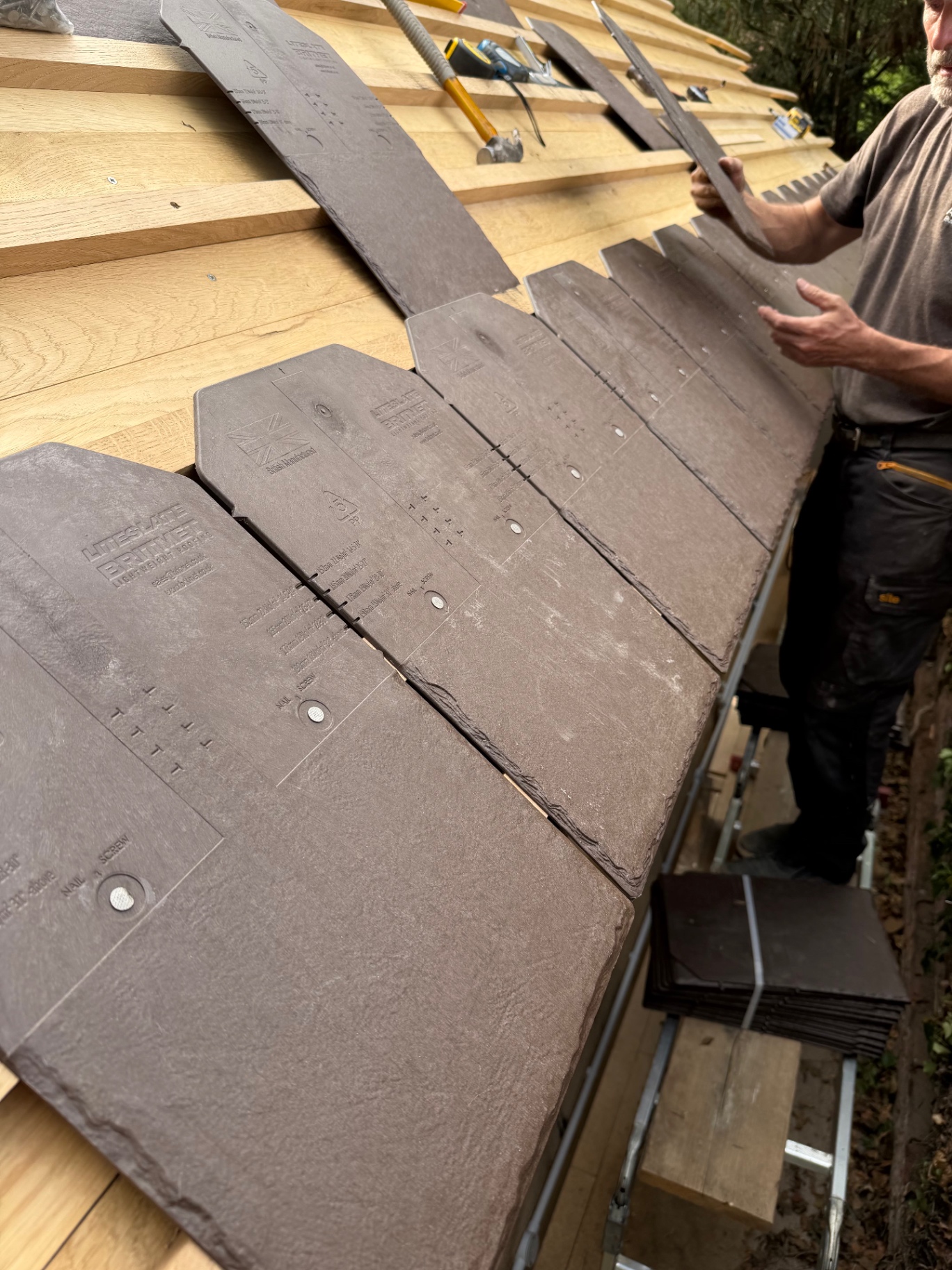 Lightweight slates being set out on the gazebo roof in Godmanchester, Cambridgeshire