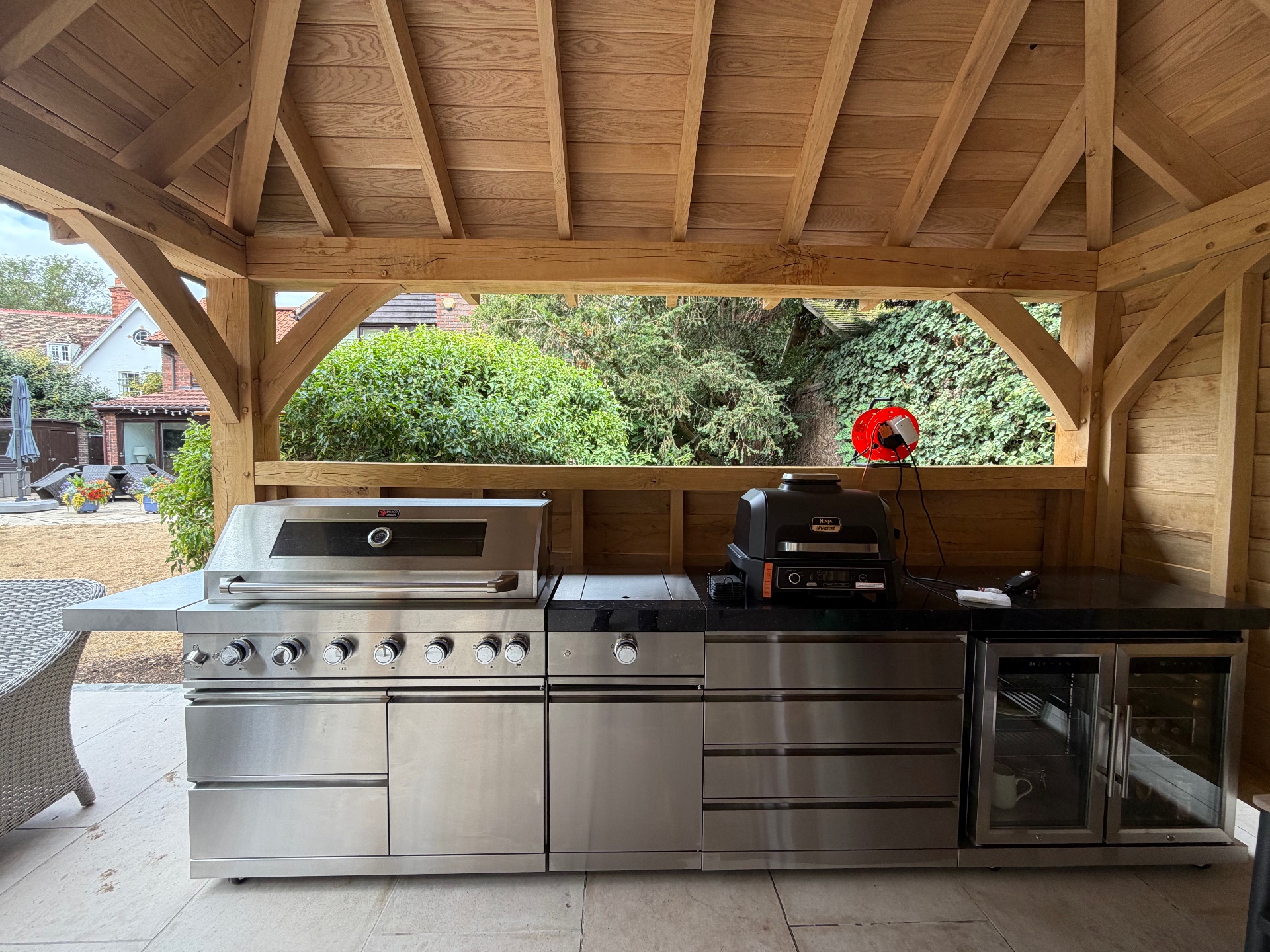 Outdoor kitchen with built-in barbecue and fridge under the oak gazebo in Godmanchester, Cambridgeshire