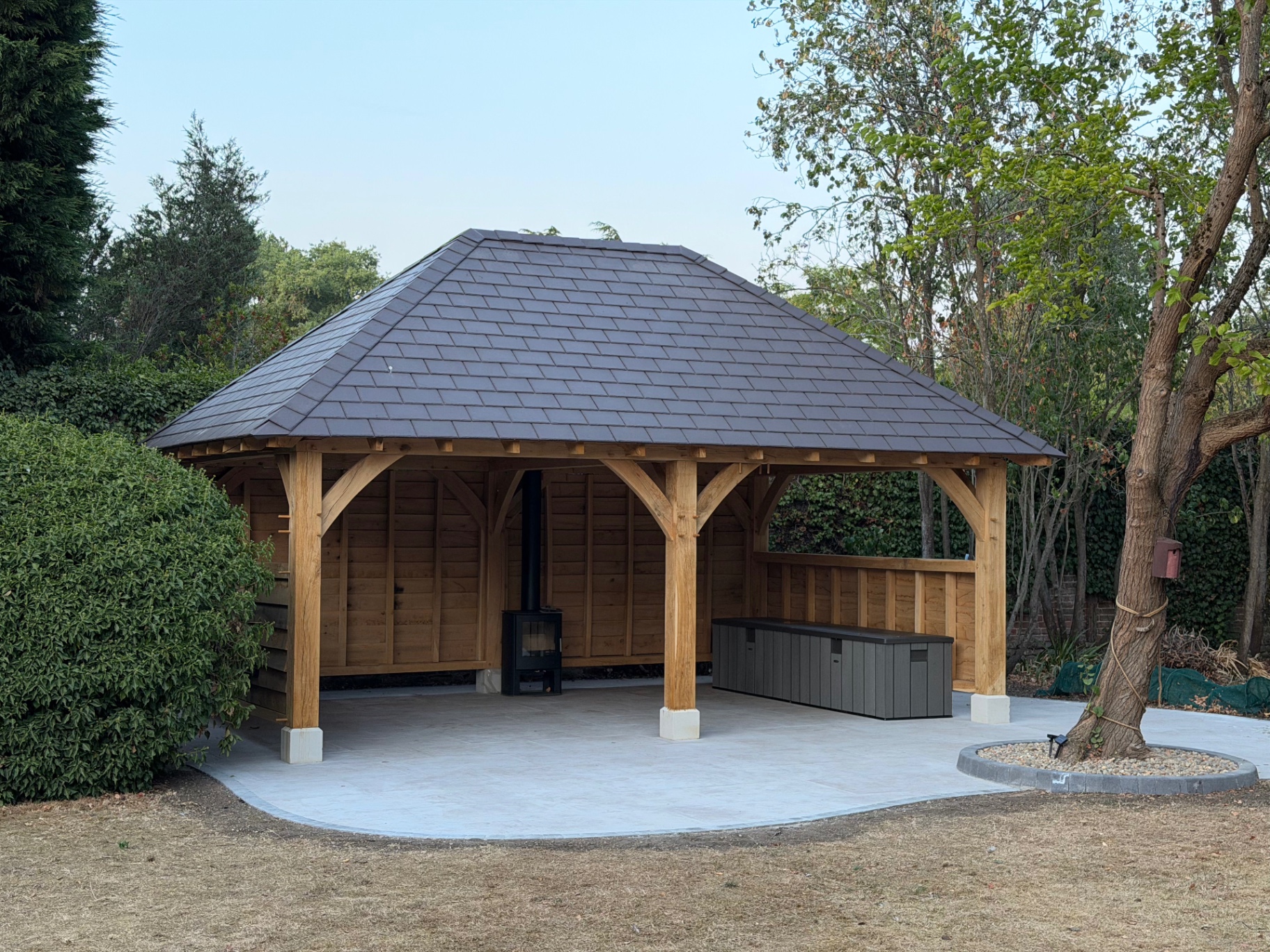Finished oak gazebo with log burner and porcelain patio in Godmanchester, Cambridgeshire