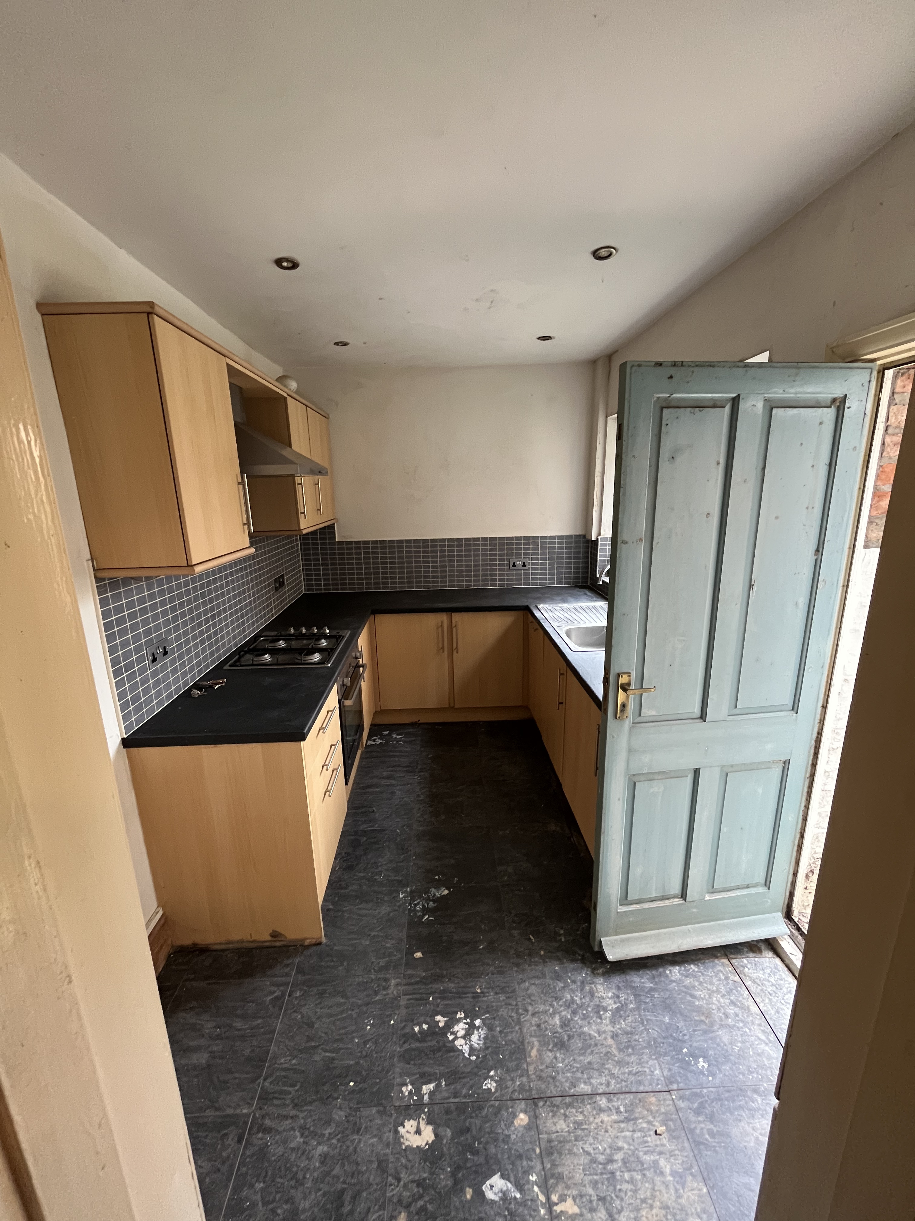 Cramped original kitchen with damp issues and dated units before renovation in Cambridgeshire
