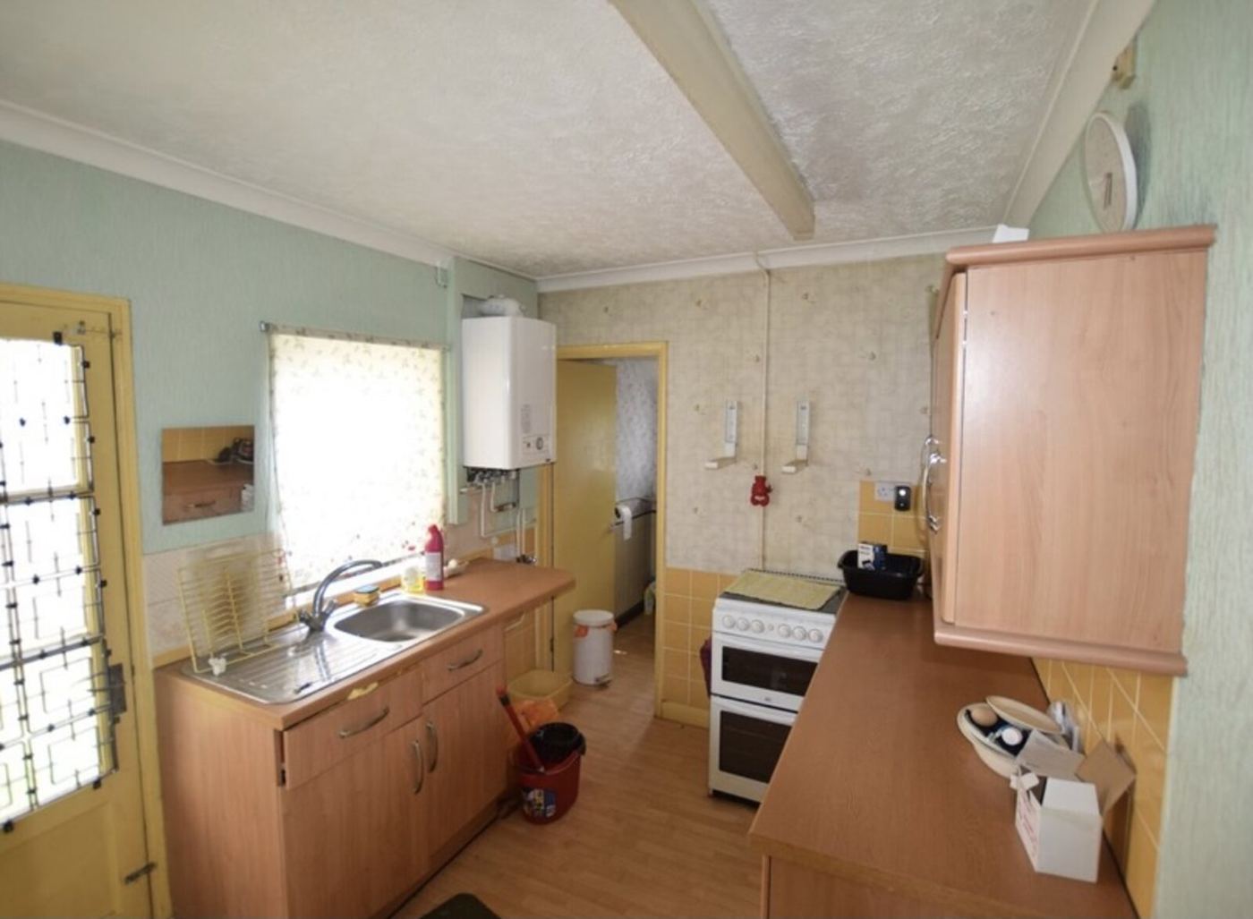 Tired, dated kitchen in a central Bedford terrace before full back-to-brick renovation by Arcadia Build & Landscape