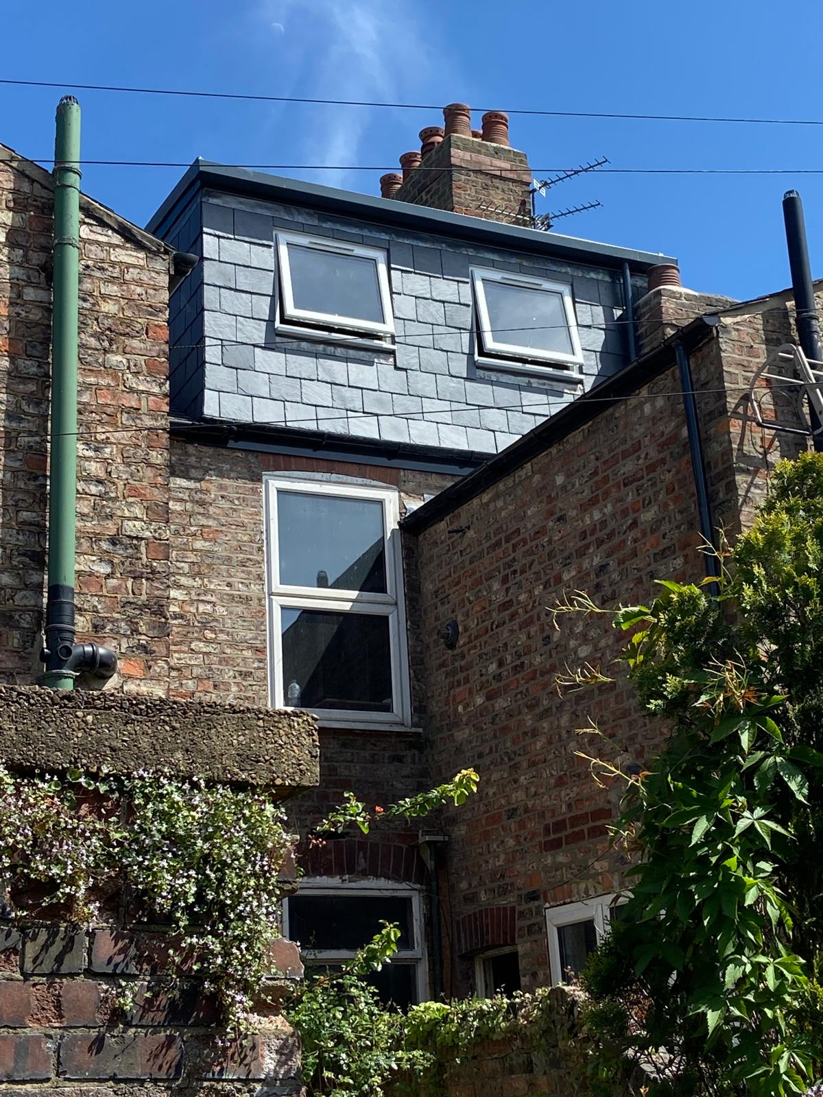 Completed slate-clad dormer loft conversion on a period brick home in Cambridgeshire