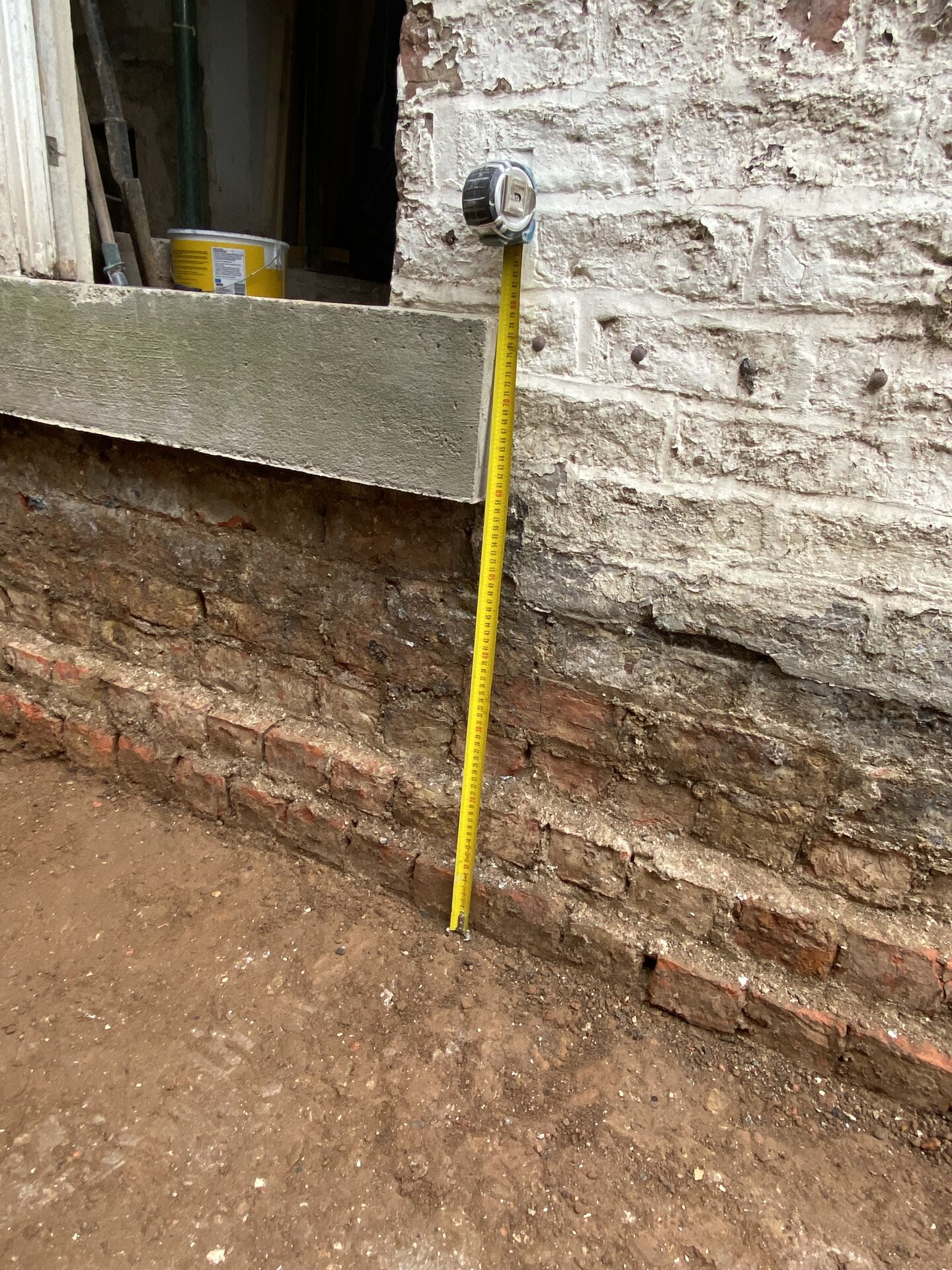 Tape measure showing depth of dig for raft foundation in Cambridgeshire side extension