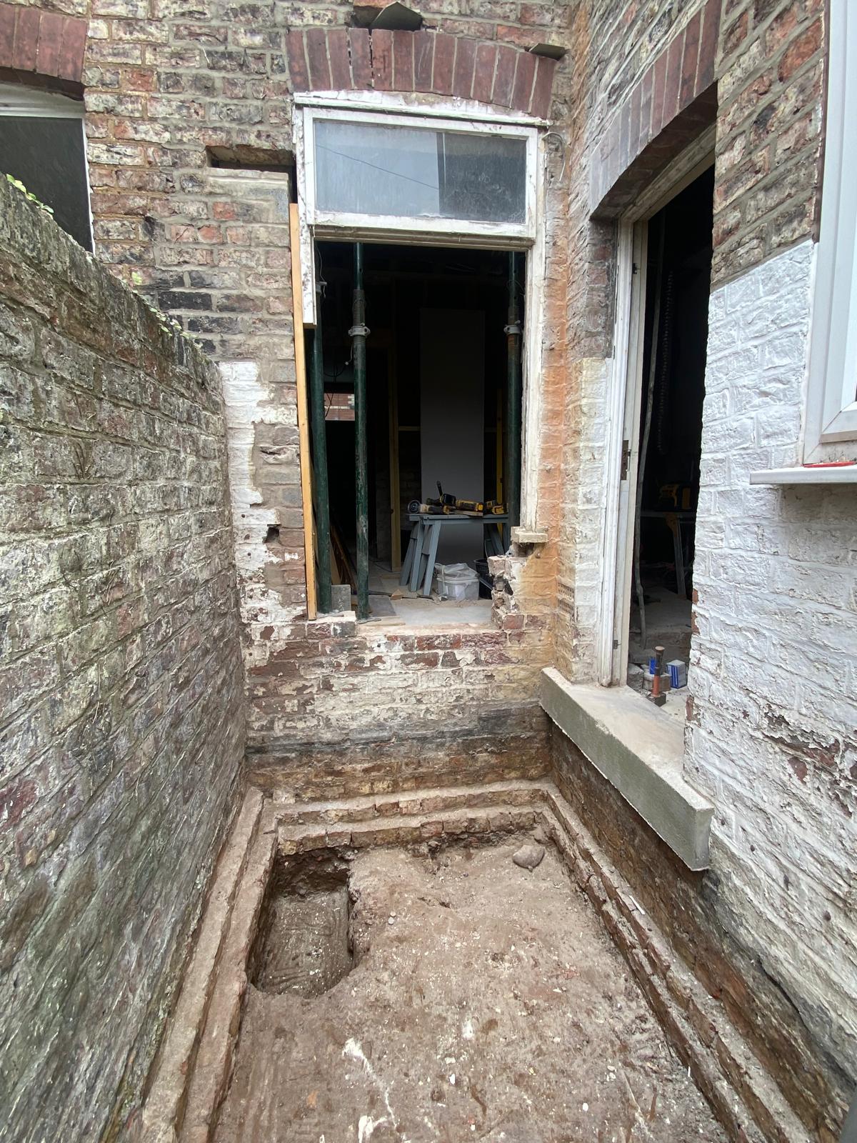 Existing brickwork removed and footings dug out for new side extension in Cambridgeshire