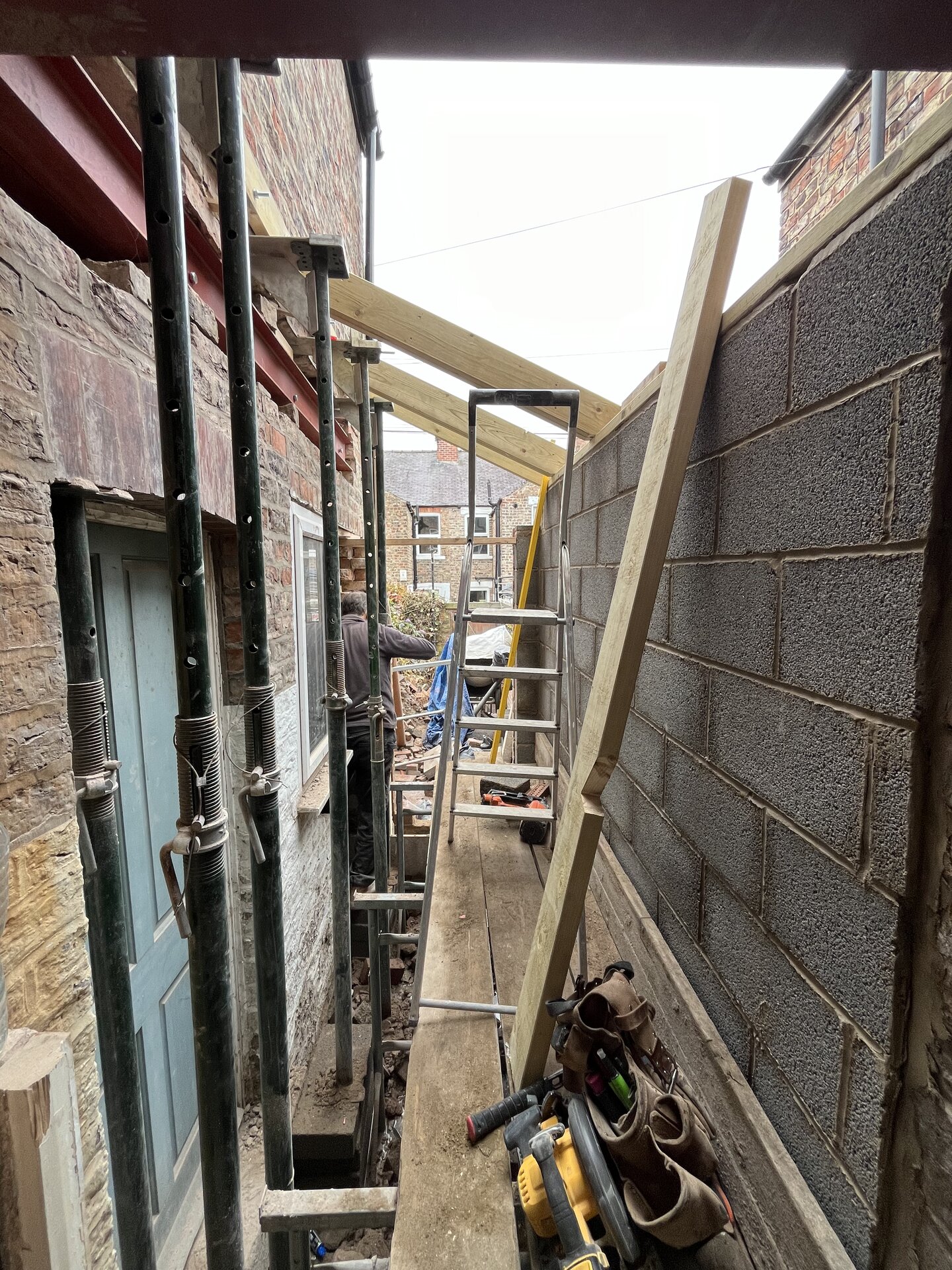 Timber floor joists hung from steel beam inside Cambridgeshire side extension