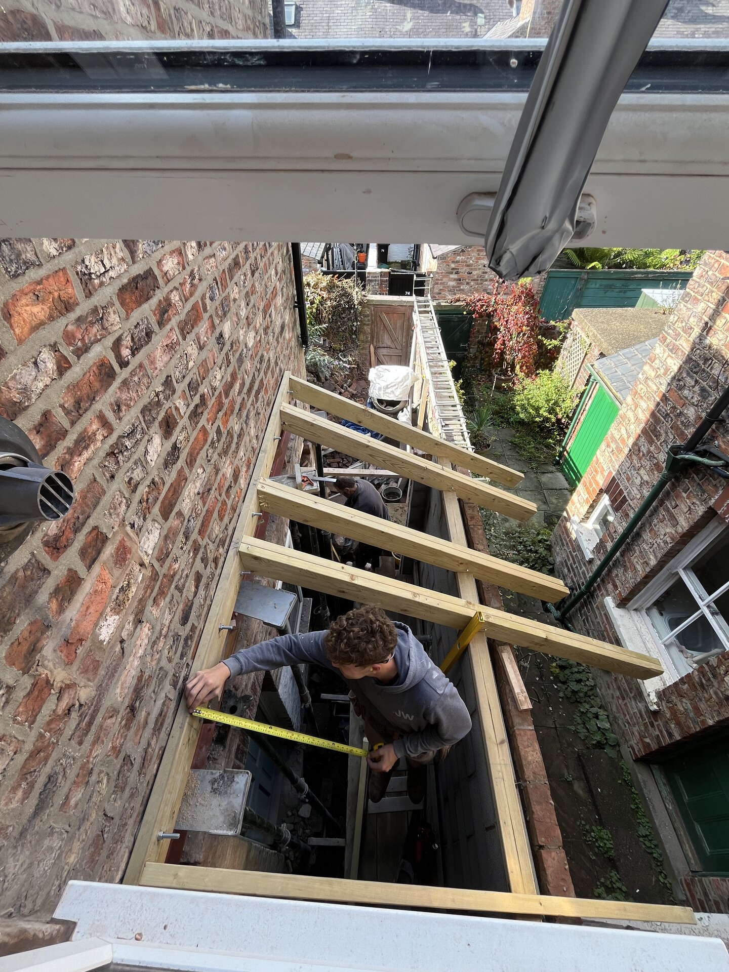 Internal view of new extension shell with blockwork walls and timber roof structure in Cambridgeshire