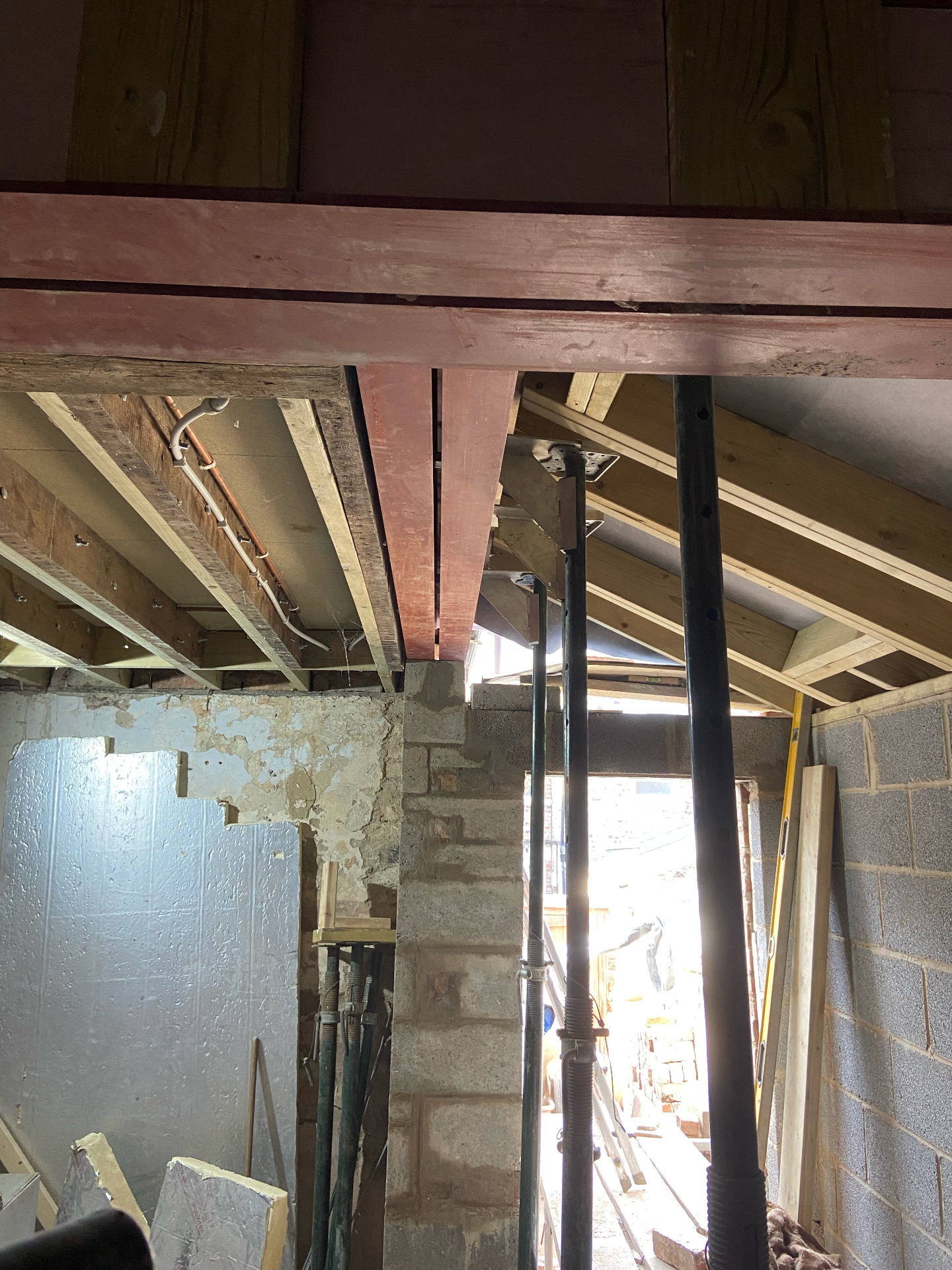 New steel beam pinned into existing timber floor joists inside Cambridgeshire extension