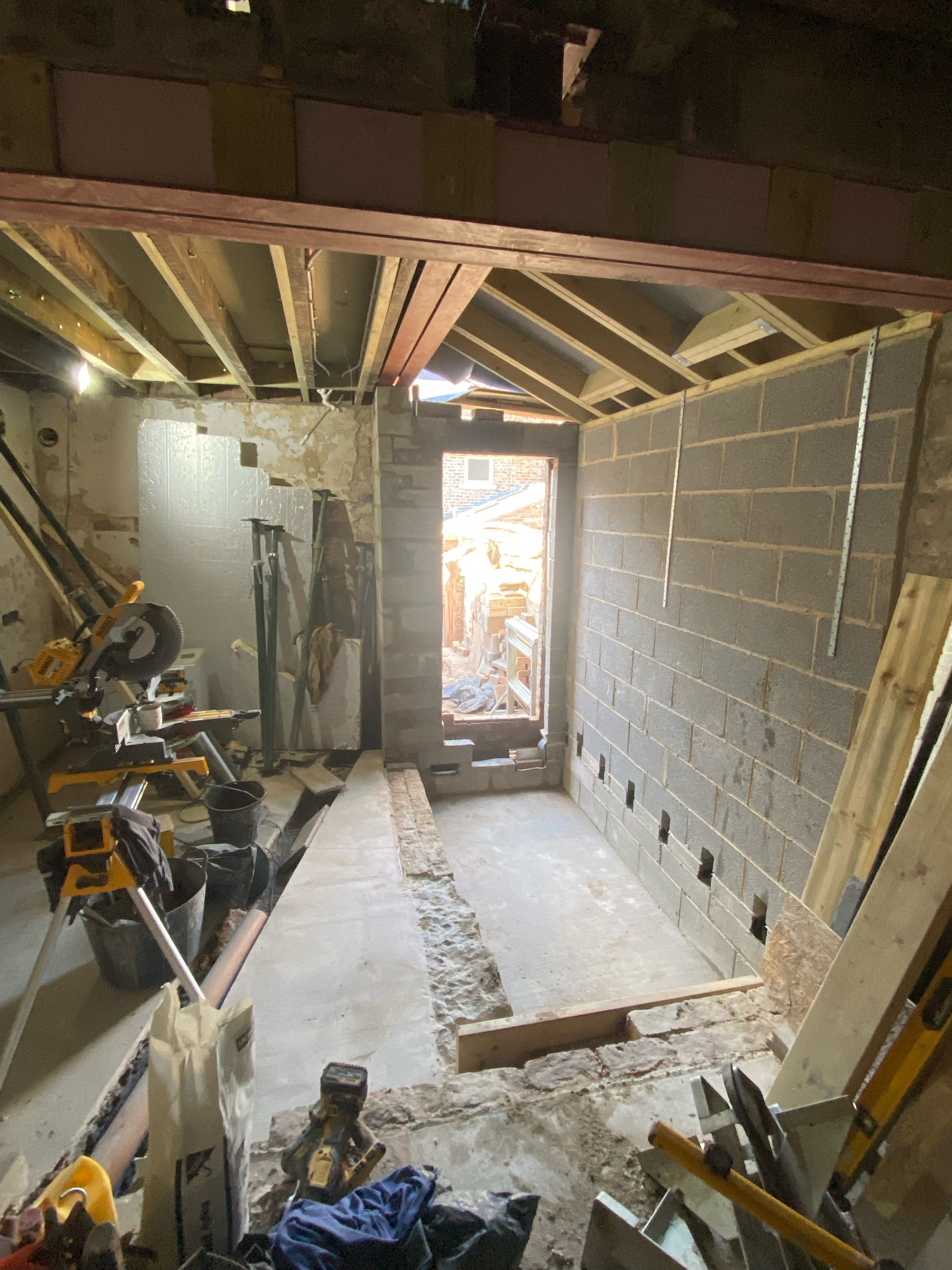 Internal shell of new Cambridgeshire side extension with blockwork walls and roof joists