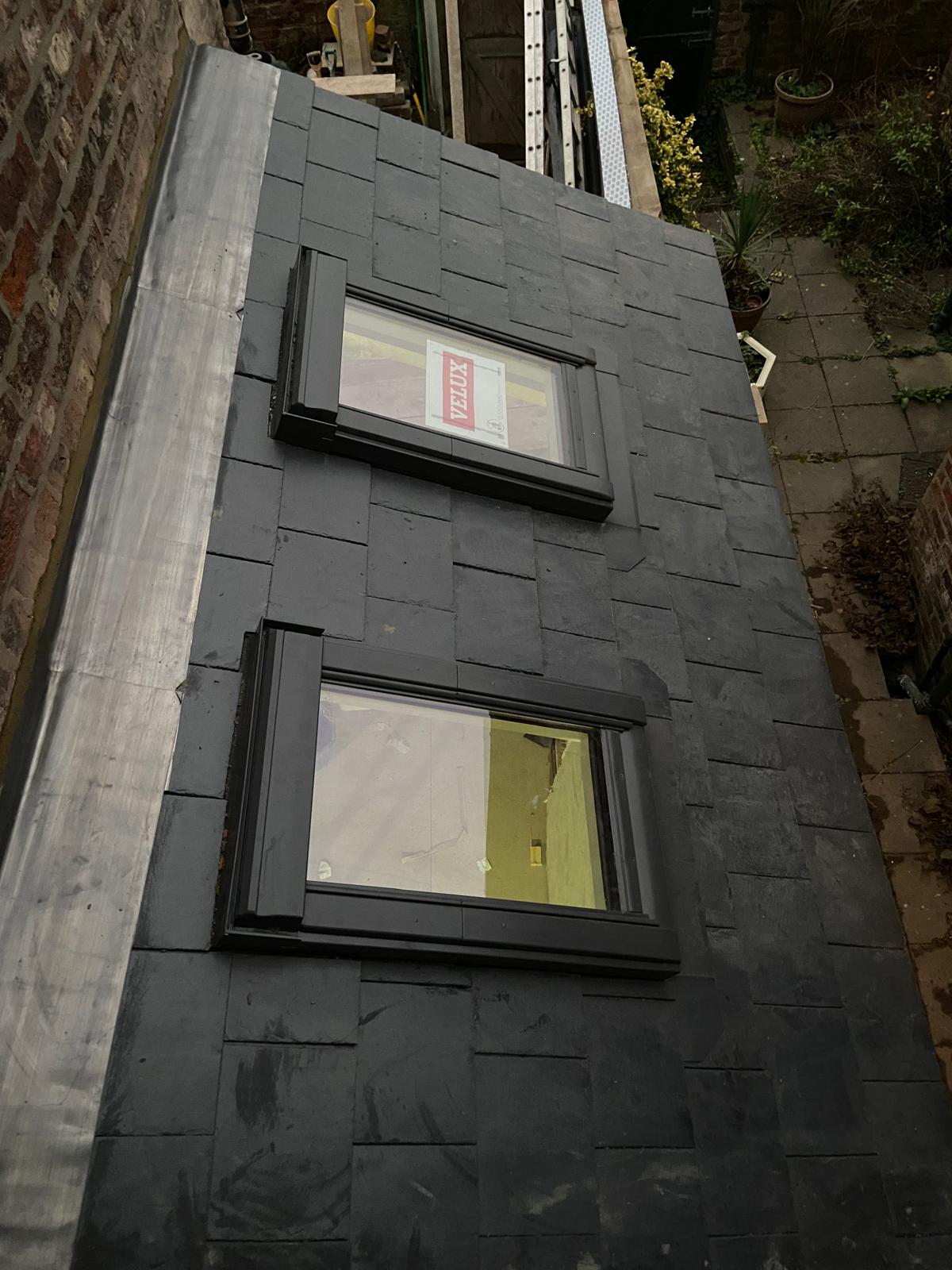 Natural slate roof with two new Velux windows on Cambridgeshire side extension
