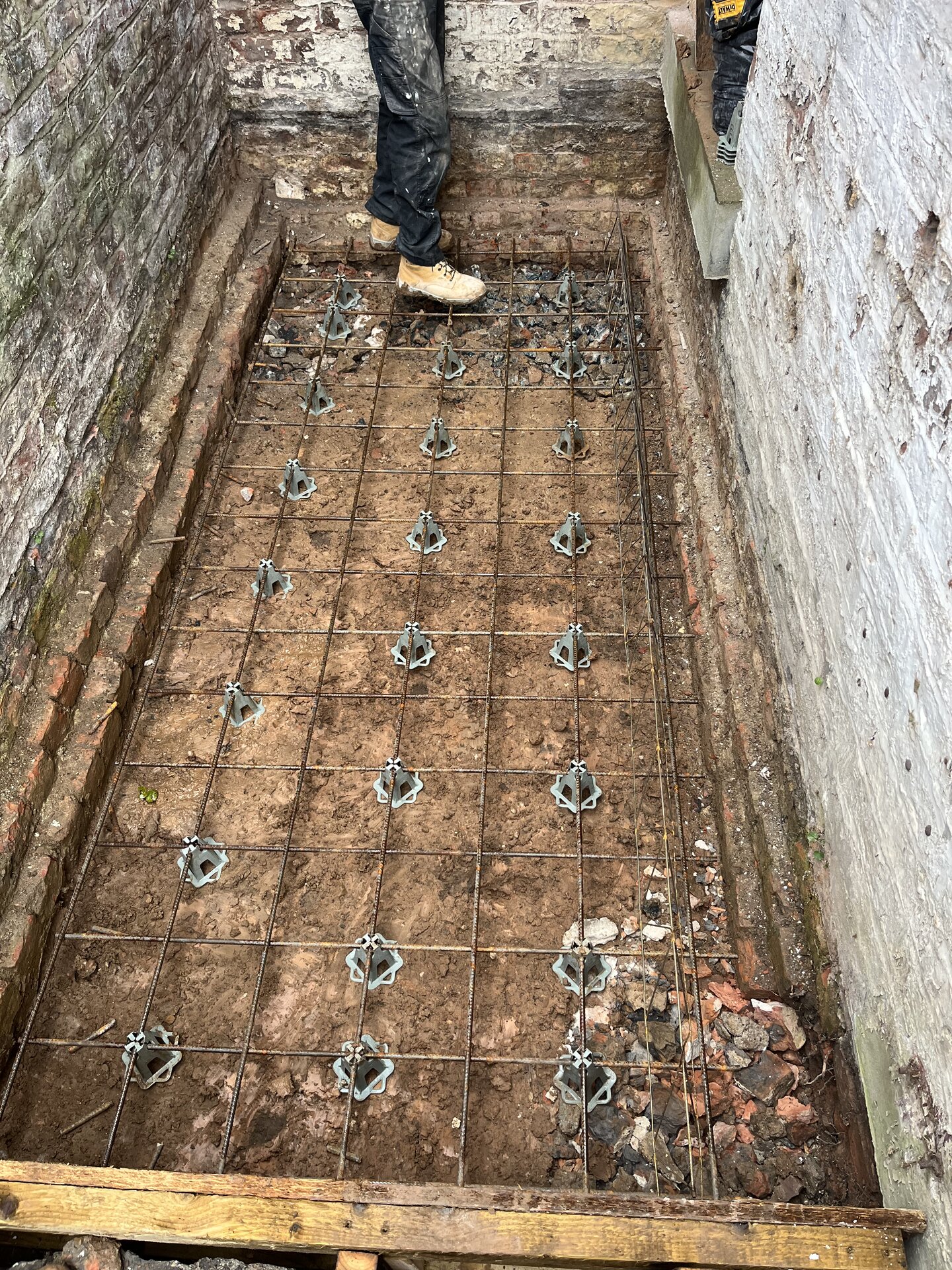 Steel reinforcement mesh laid across the full footprint for raft foundation in Cambridgeshire