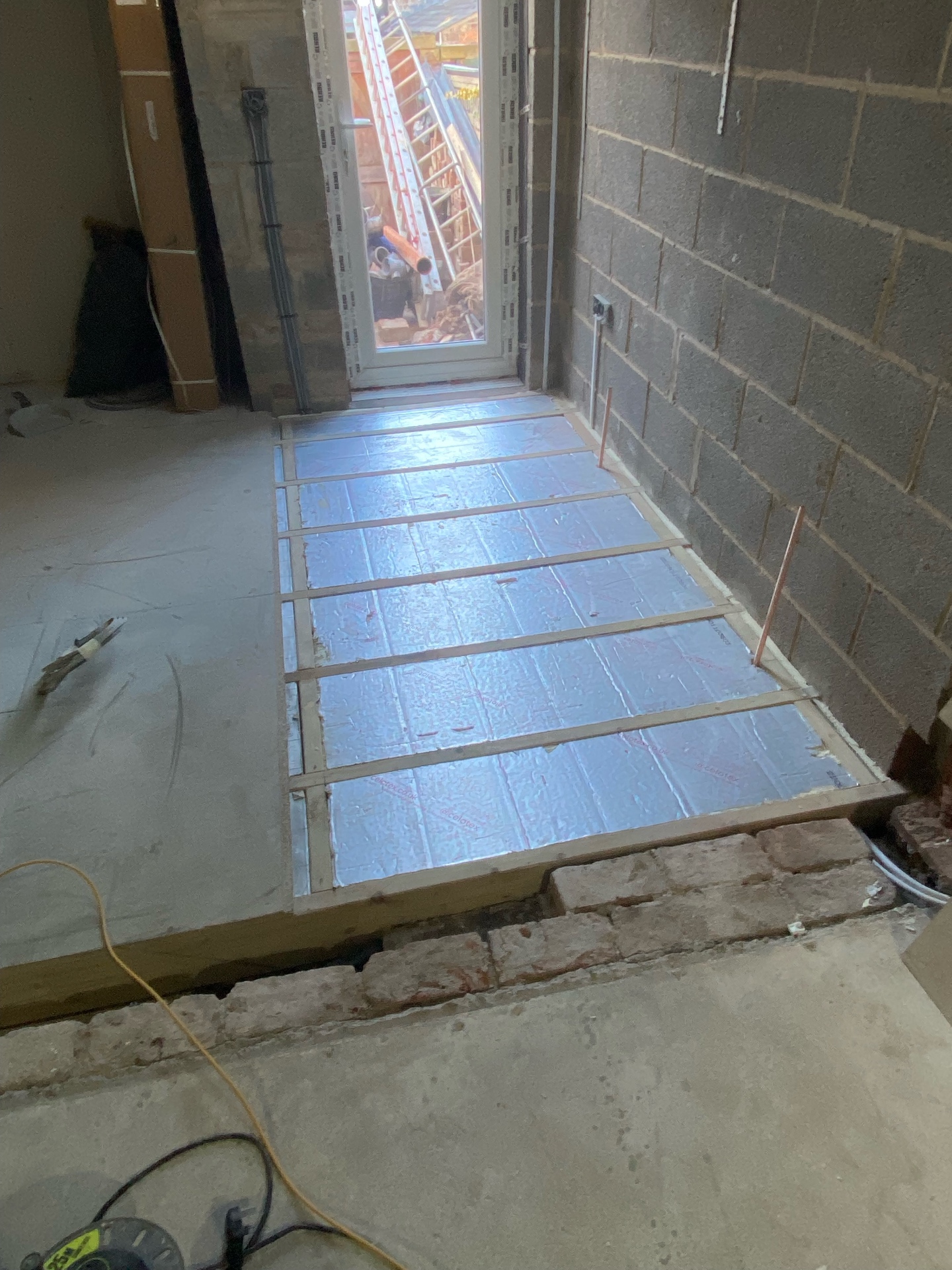 Underfloor heating insulation boards laid between battens in Cambridgeshire extension