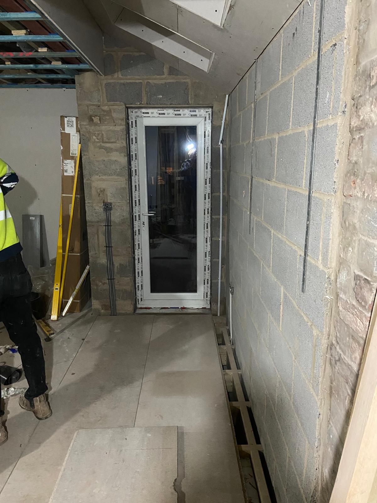 New chipboard floor laid alongside service void with external door fitted in Cambridgeshire extension