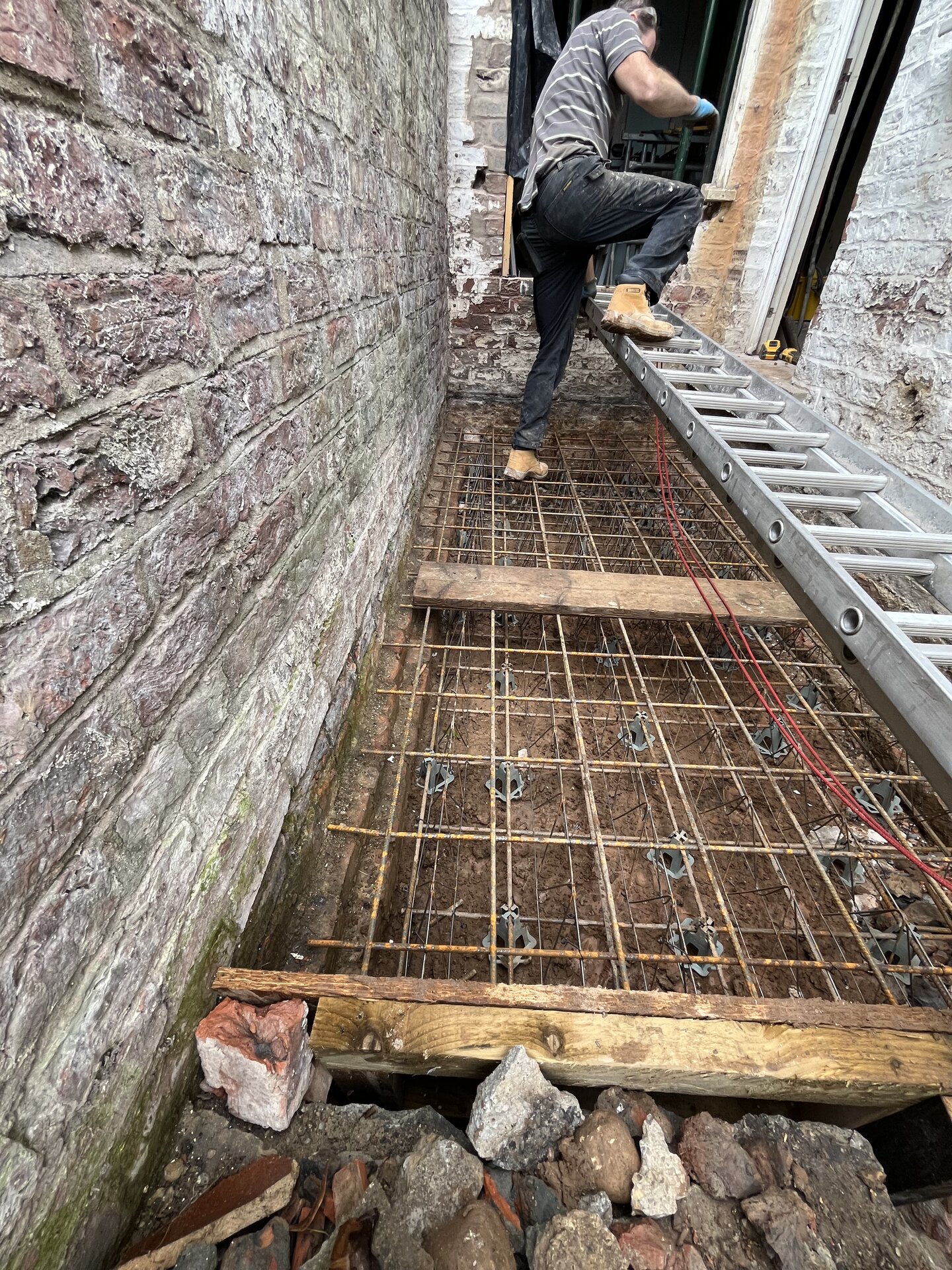 Reinforcement mesh and chairs in place ready for concrete raft foundation pour in Cambridgeshire
