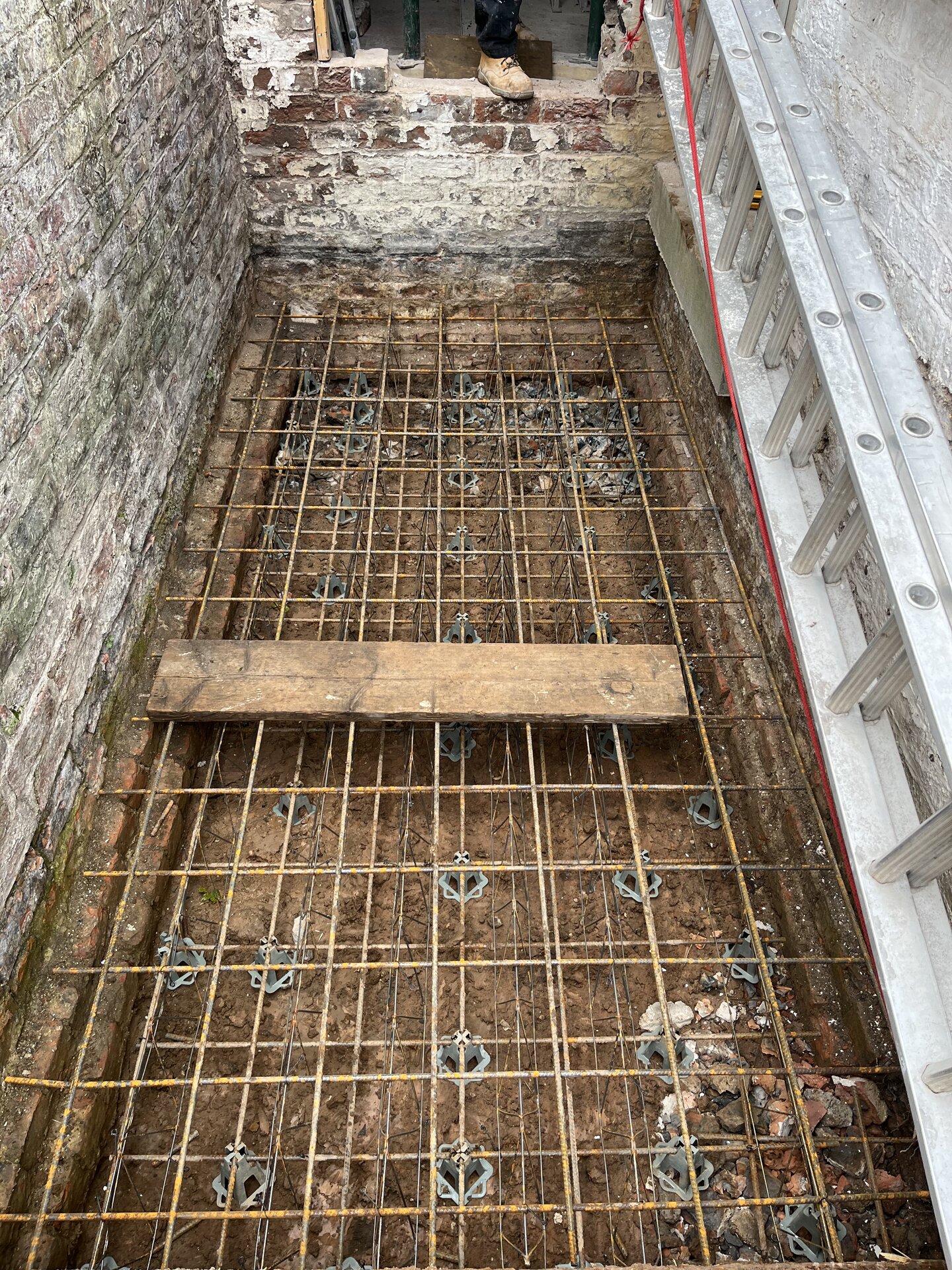 Wide view of reinforced concrete raft foundation prep for side extension in Cambridgeshire