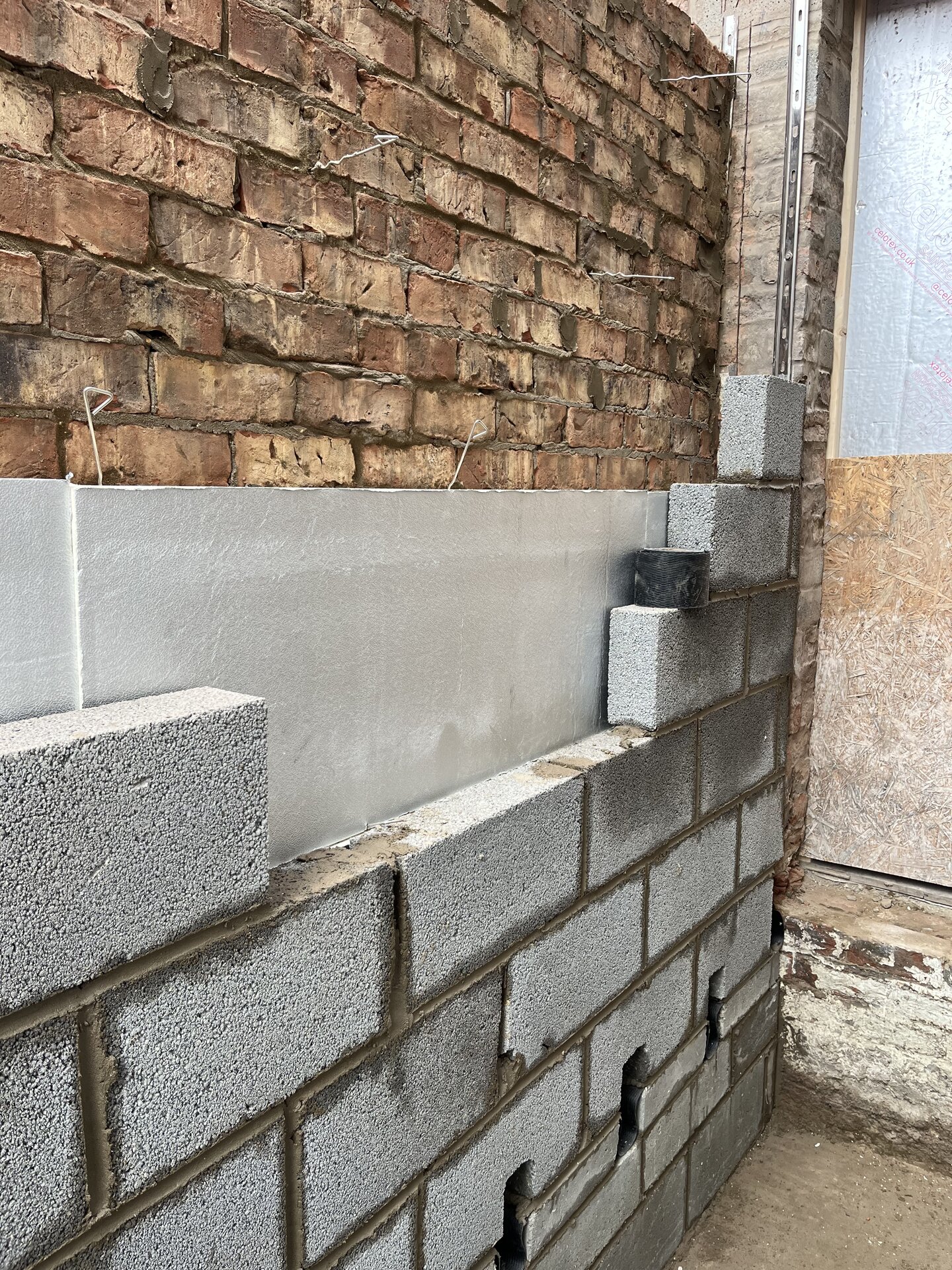 Cavity wall block and brickwork with insulation going up on Cambridgeshire side extension