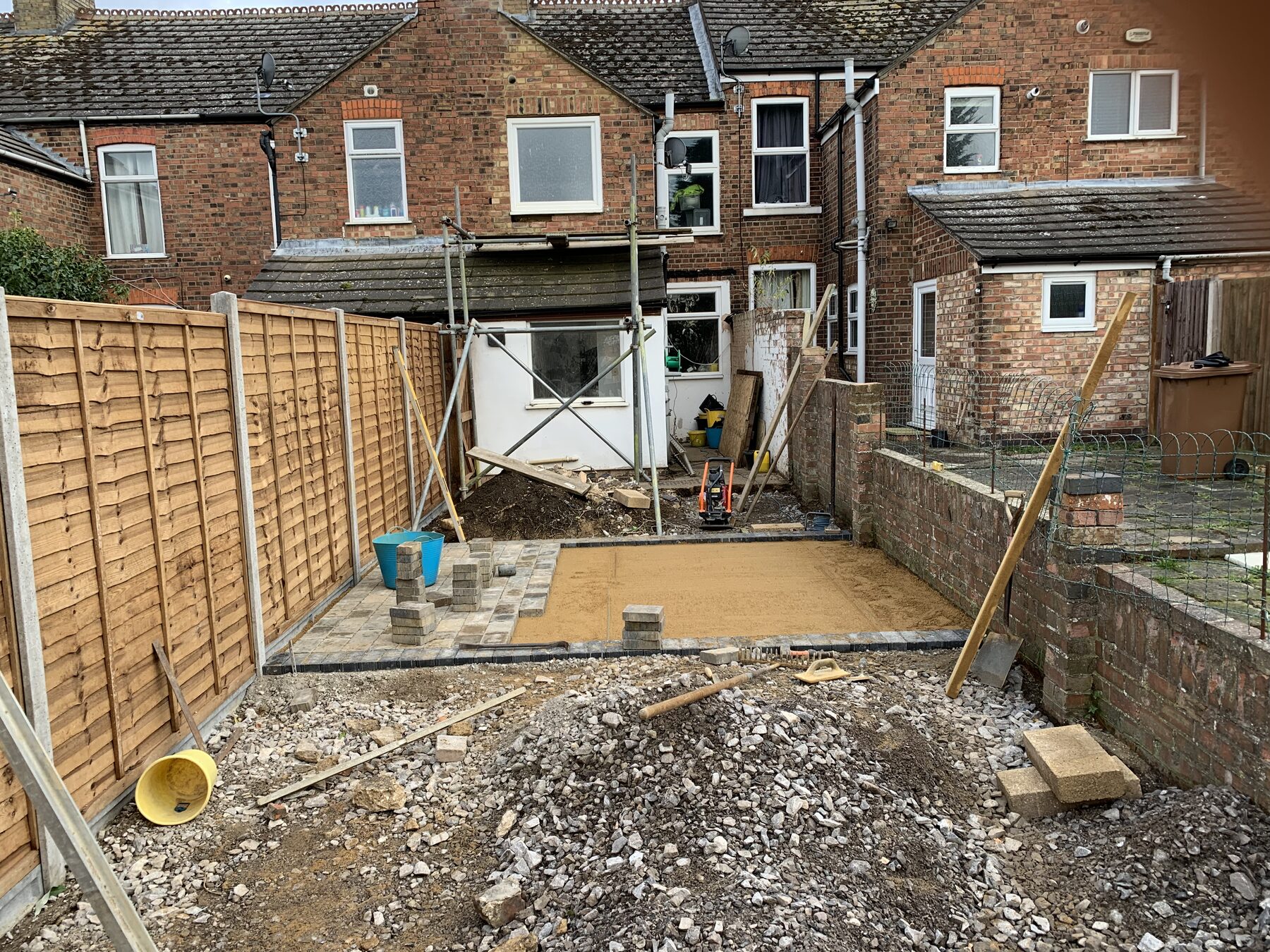 Main patio area with charcoal border and sand screed ready for block paving in Fletton