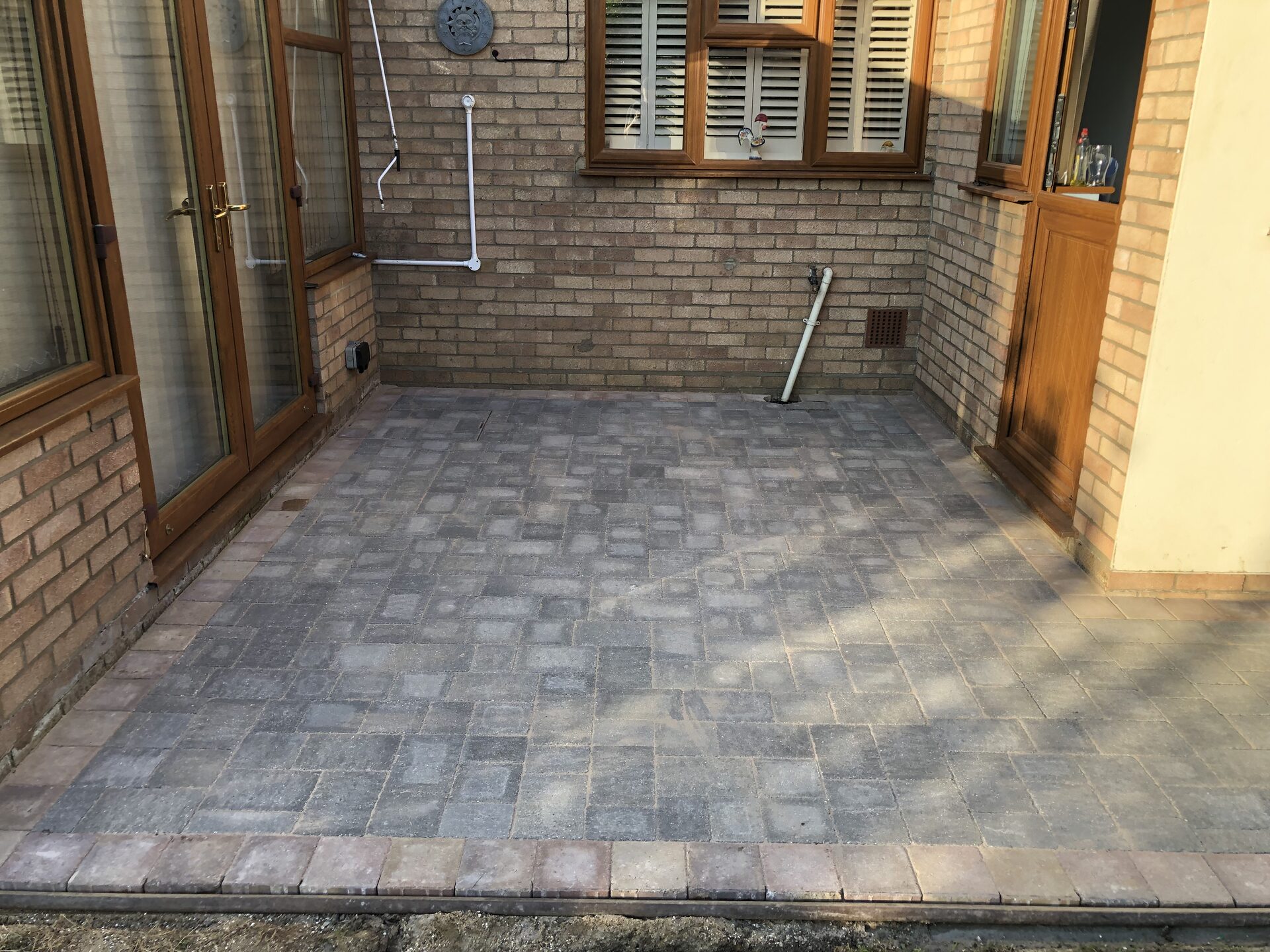 Finished block-paved patio outside conservatory in Folksworth, Cambridgeshire