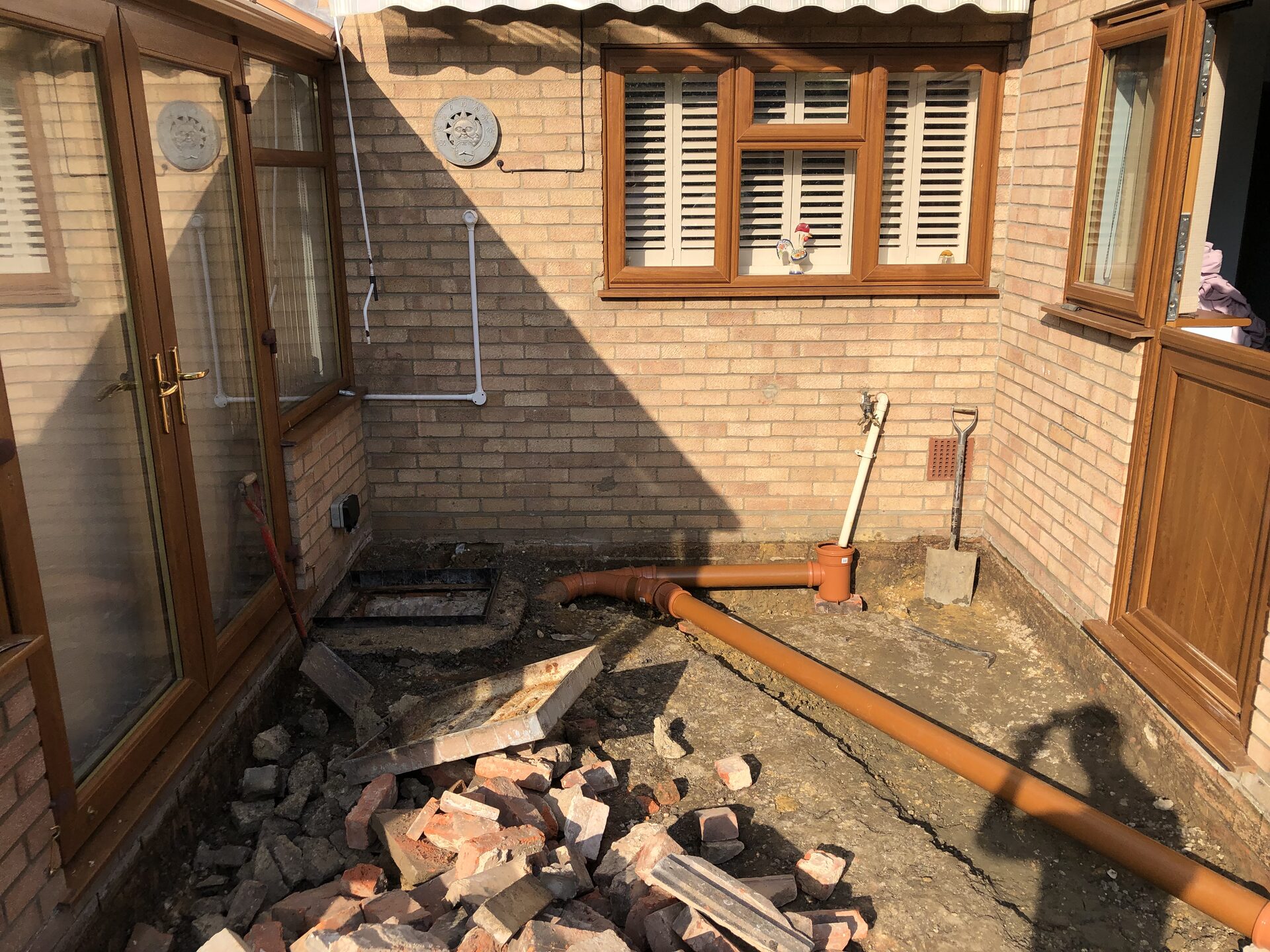 New orange soil drainage pipework installed correctly in Folksworth, Cambridgeshire
