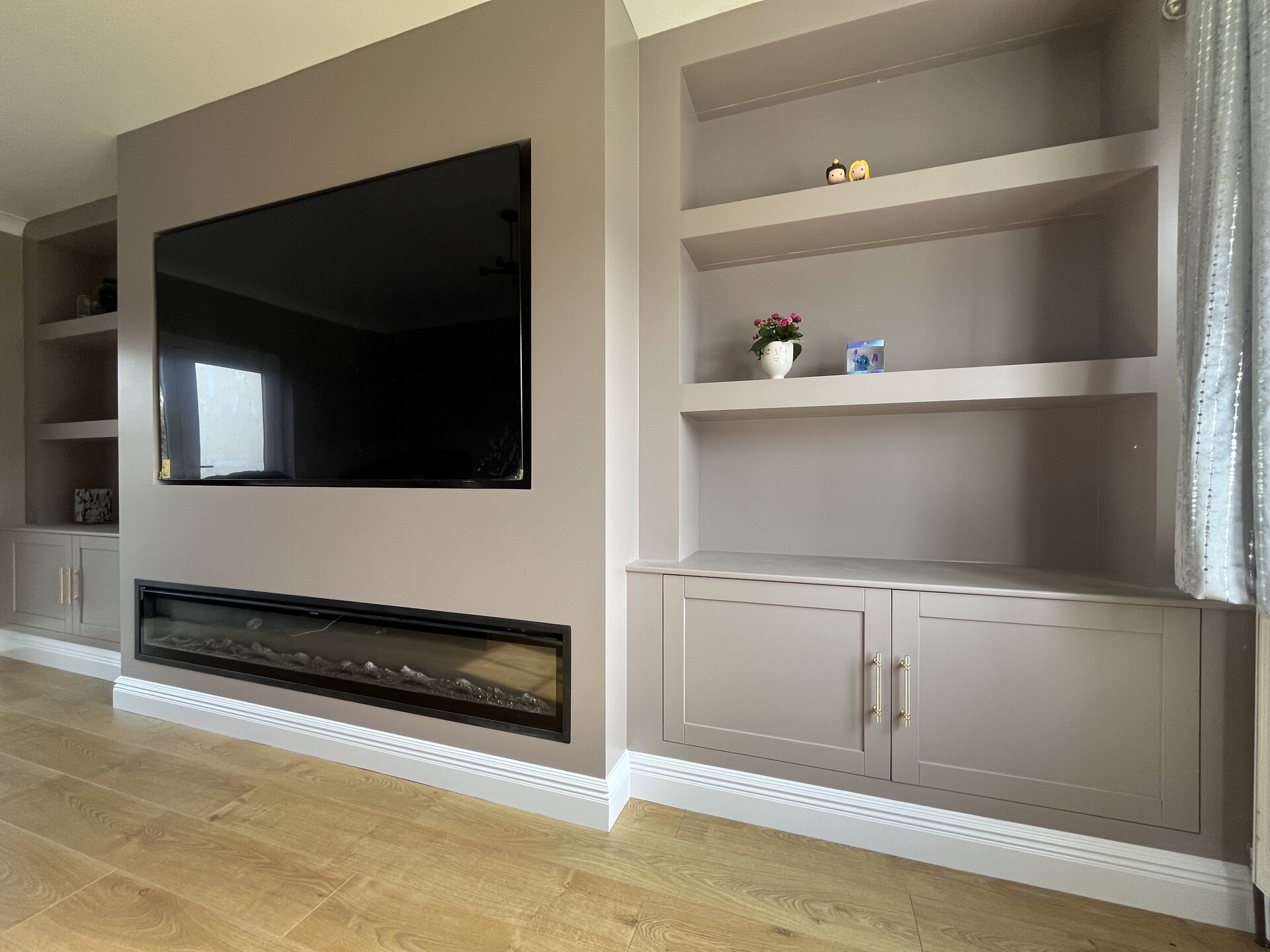 Bespoke media wall transformation with 77-inch screen and electric fireplace in Sawtry, Cambridgeshire