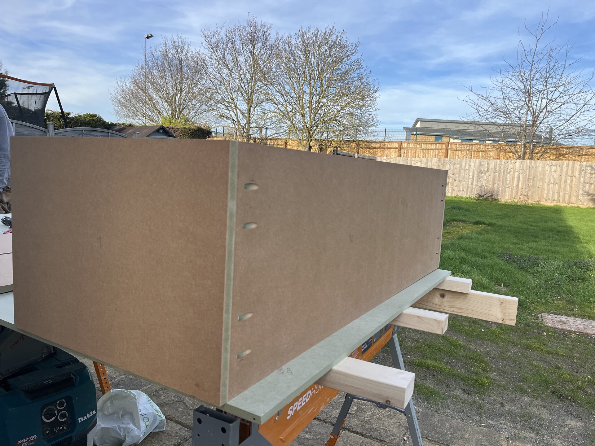 MDF panel being prepared with pocket-hole joinery for the media wall carcass