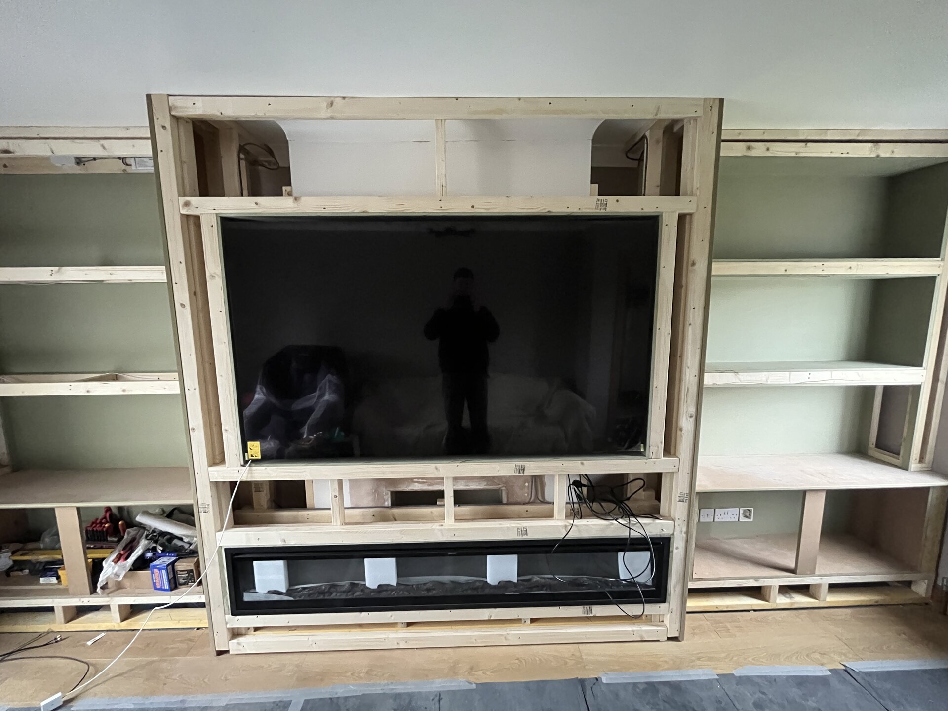 Lower alcove unit fitted in place with cable cut-outs in Sawtry living room