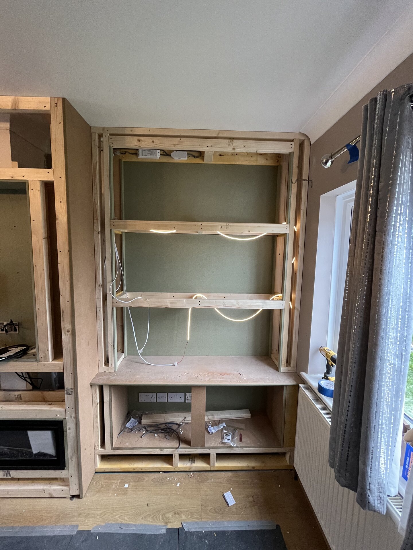 Side alcove framework with concealed lighting wiring and integrated shelving in Sawtry