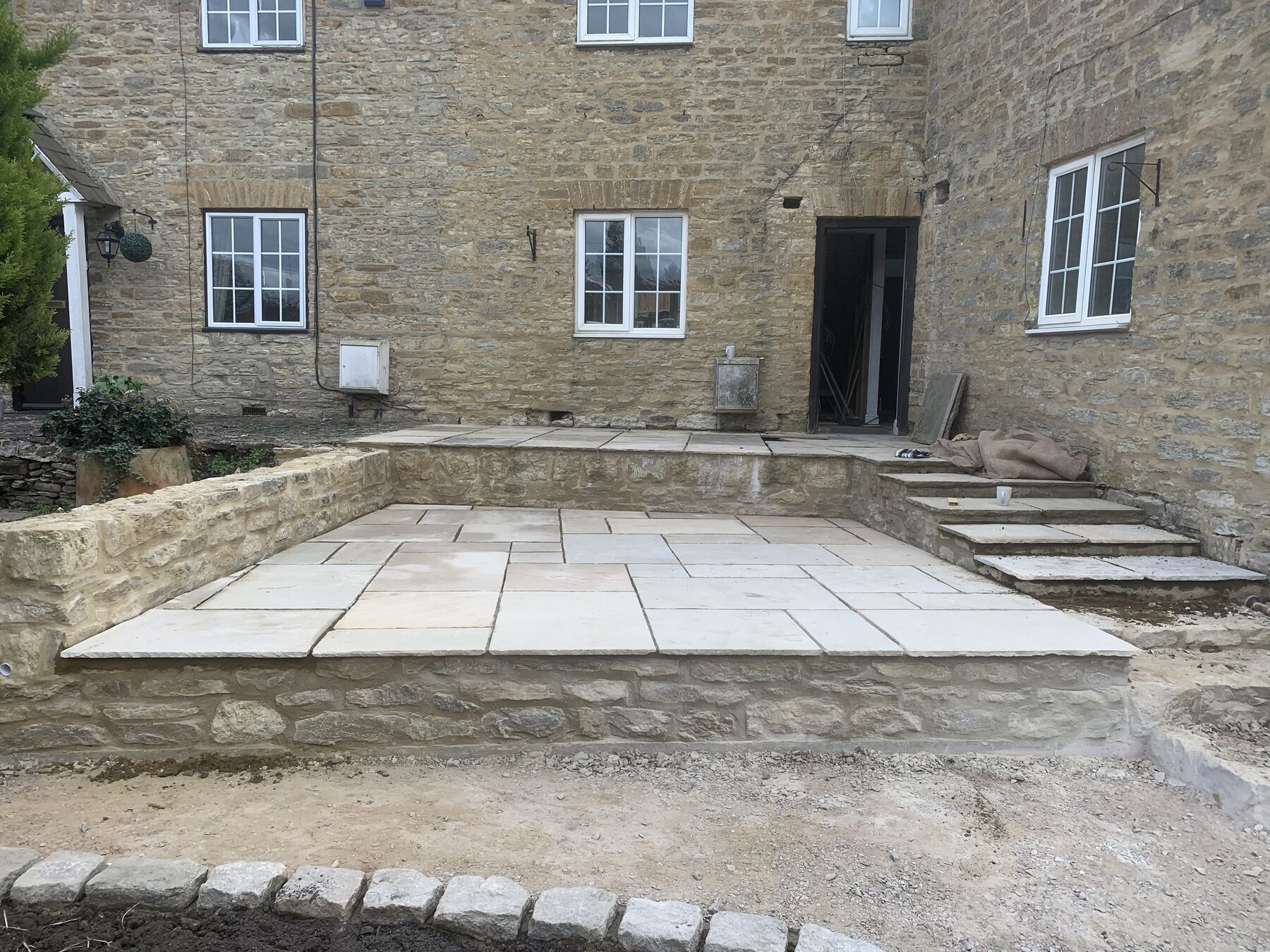 Reclaimed sandstone flags laid up to the front door of period cottage in Turvey, Bedfordshire