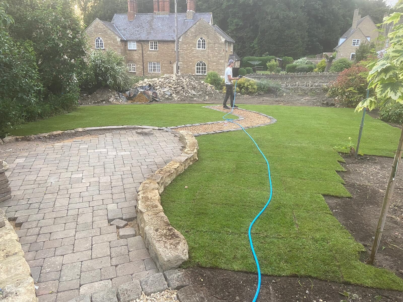 Lush green lawn, reclaimed brick paving and stone walls in newly finished rear garden in Turvey, Bedfordshire