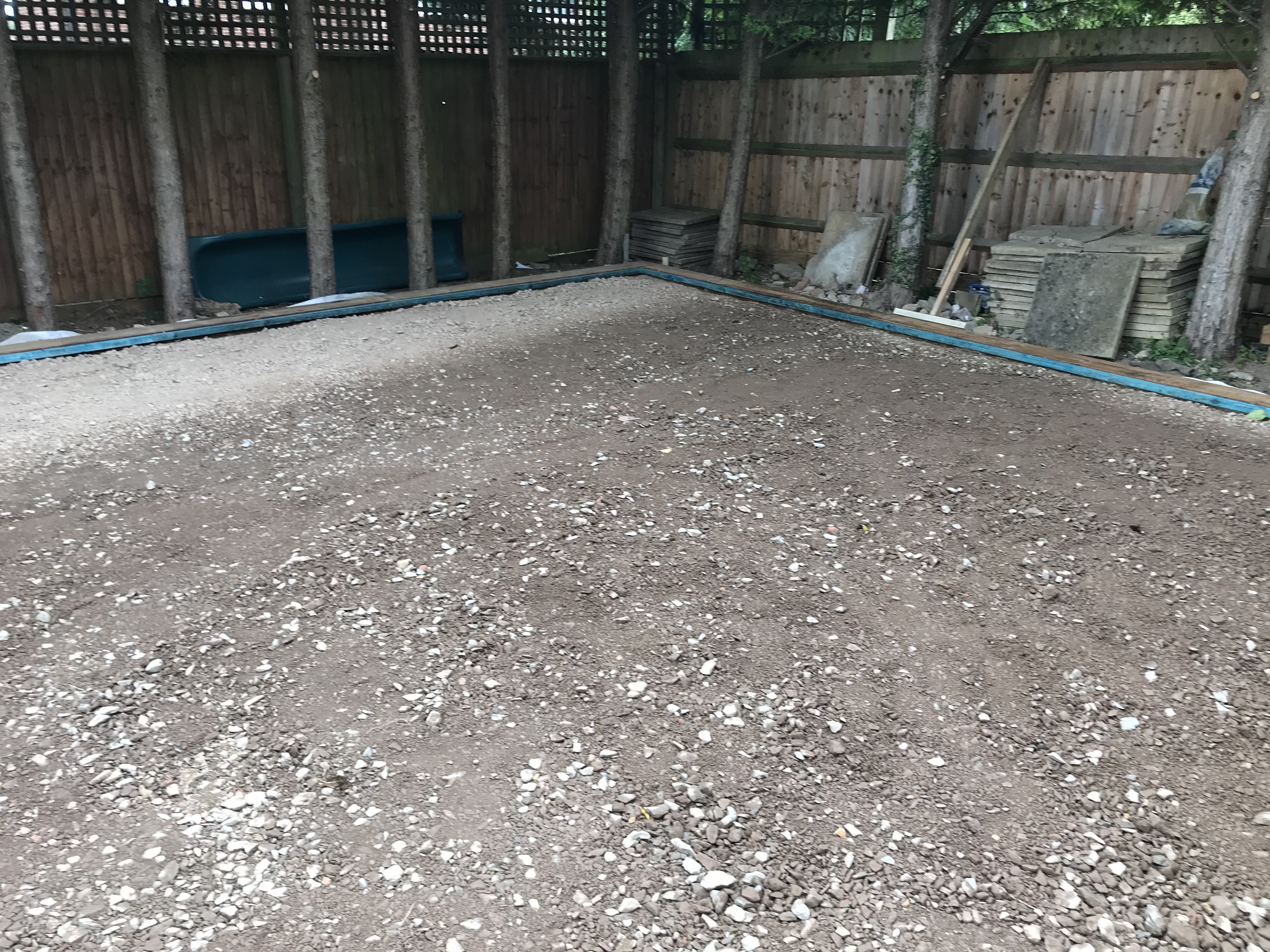 Compacted sub-base with timber sleeper edging being installed in Turvey, Bedfordshire garden